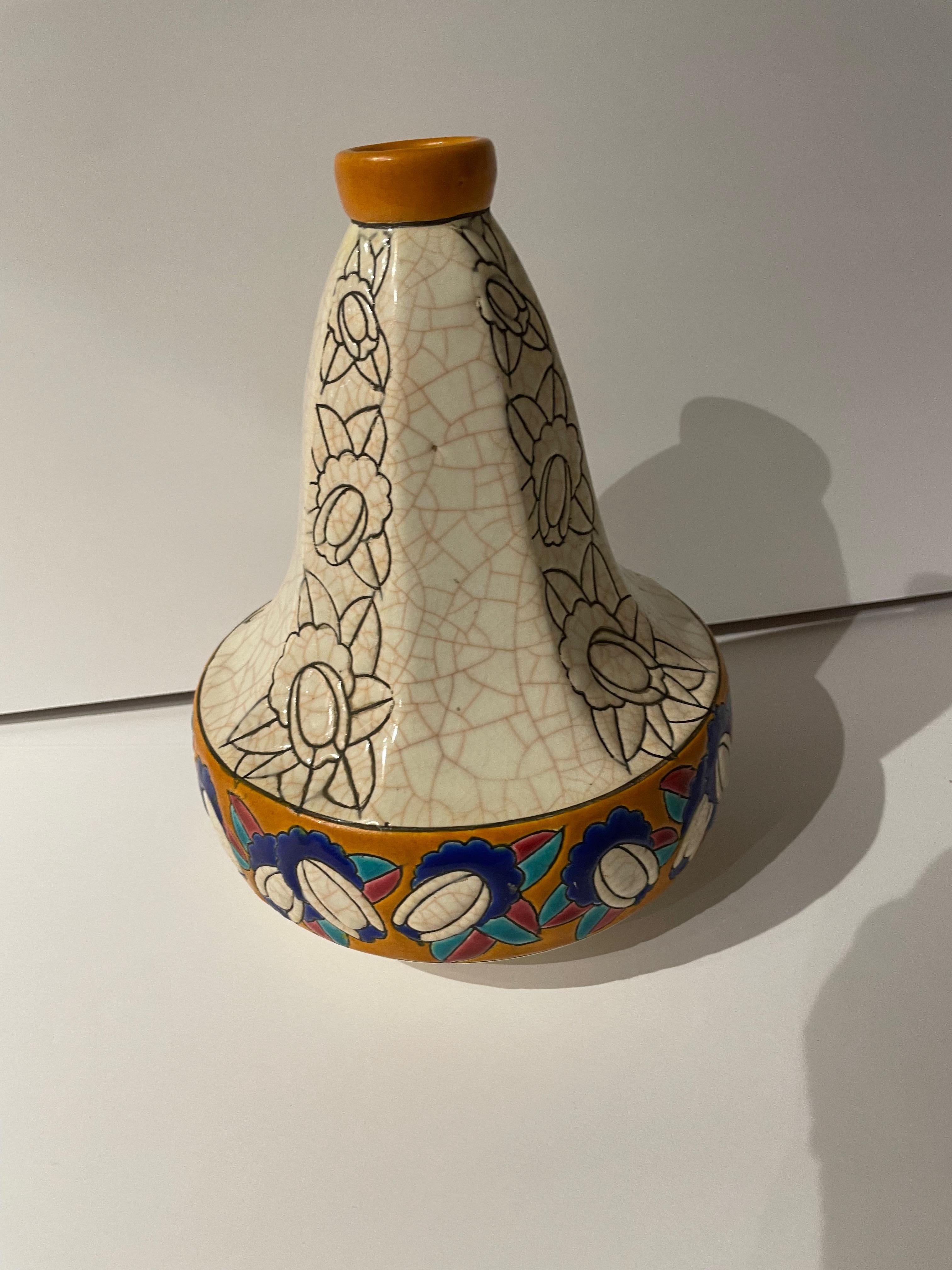 An Art Deco Vase from Longwy of France in the distinctive “pyriform” -pear or gourd shape that so many of their creations employed. Smooth, faceted sides alternate with deeply etched designs and lead down to the decorative border of geometric
