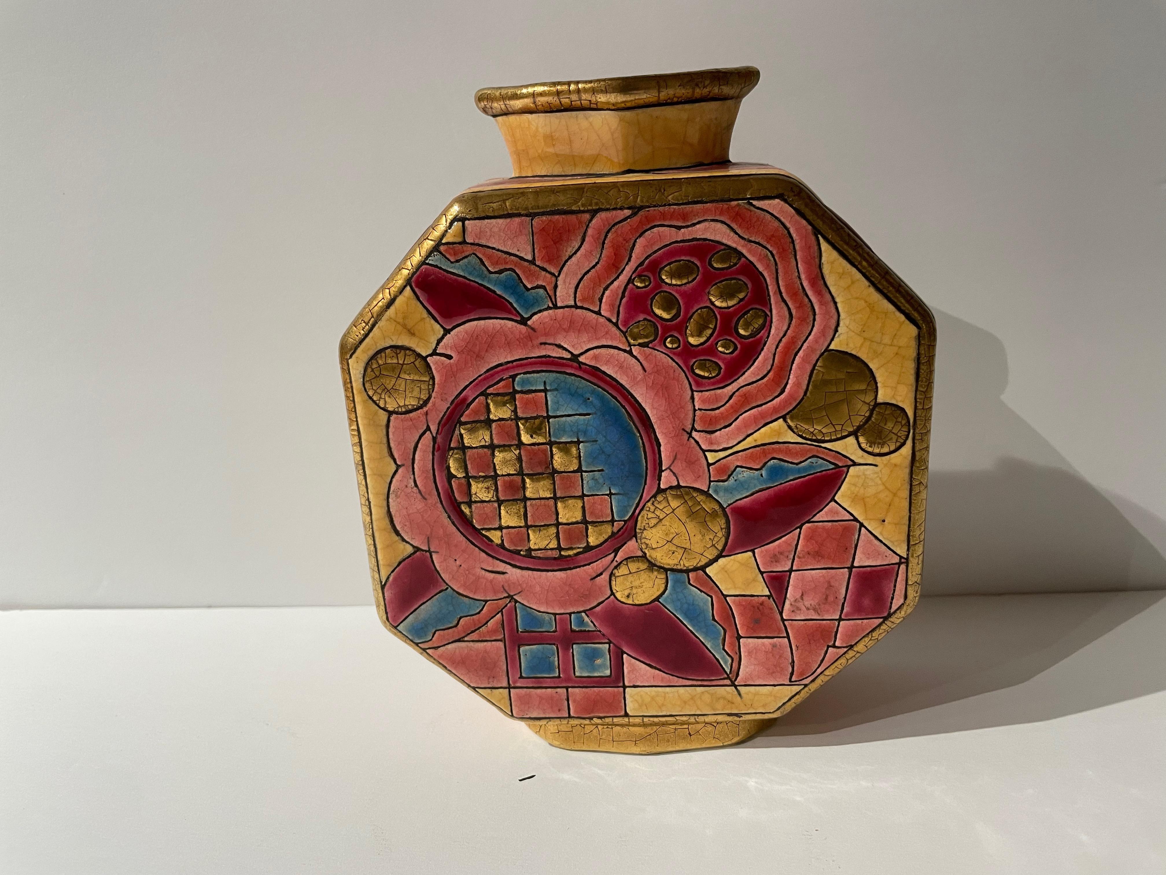 An Art Deco French Vase by Longwy from the late 1920s. This elaborately patterned and richly colored vase is highly collectible and appears in the history book of the famed Longwy Earthenware works. It mixes florals, checkered design, and gilding on