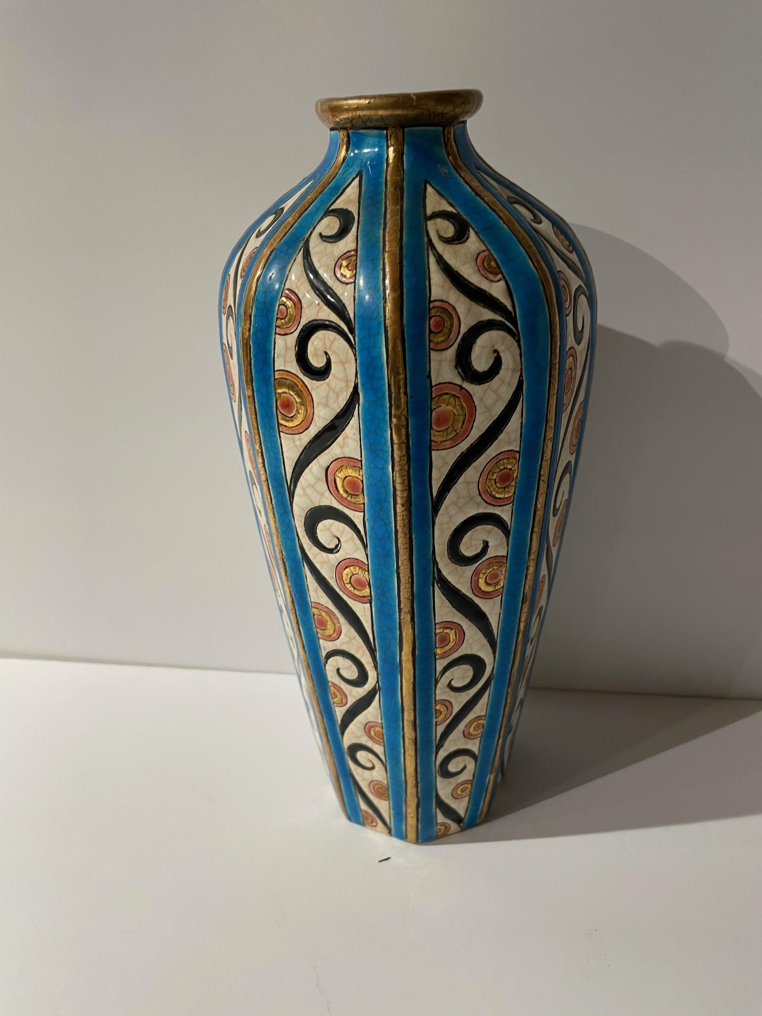 An Art Deco vase from the Longwy Earthworks of France. This piece's delightful scroll design gives it a touch of Art Nouveau influence. Done in the Ceramic Cloisonné technique for which Longwy is famous, it dates from the early 1920s.

Longwy is