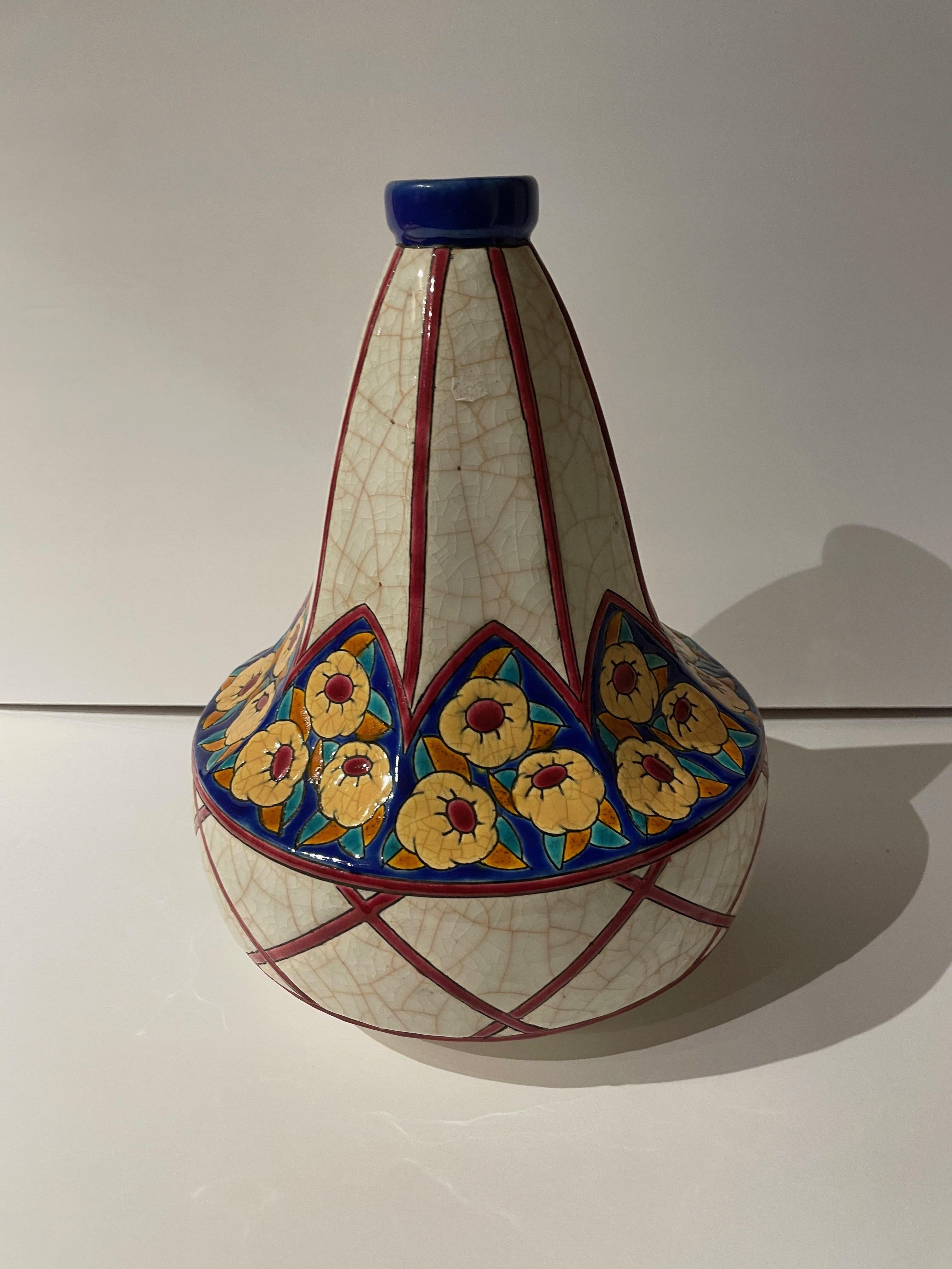 An Art Deco Vase made by Longwy in France with the technique of Ceramic Cloisonné that gives an extra dimension to the design by carving heavy lines into the pattern and filling them with rich enamel color. This is piece is in the iconic pyriform