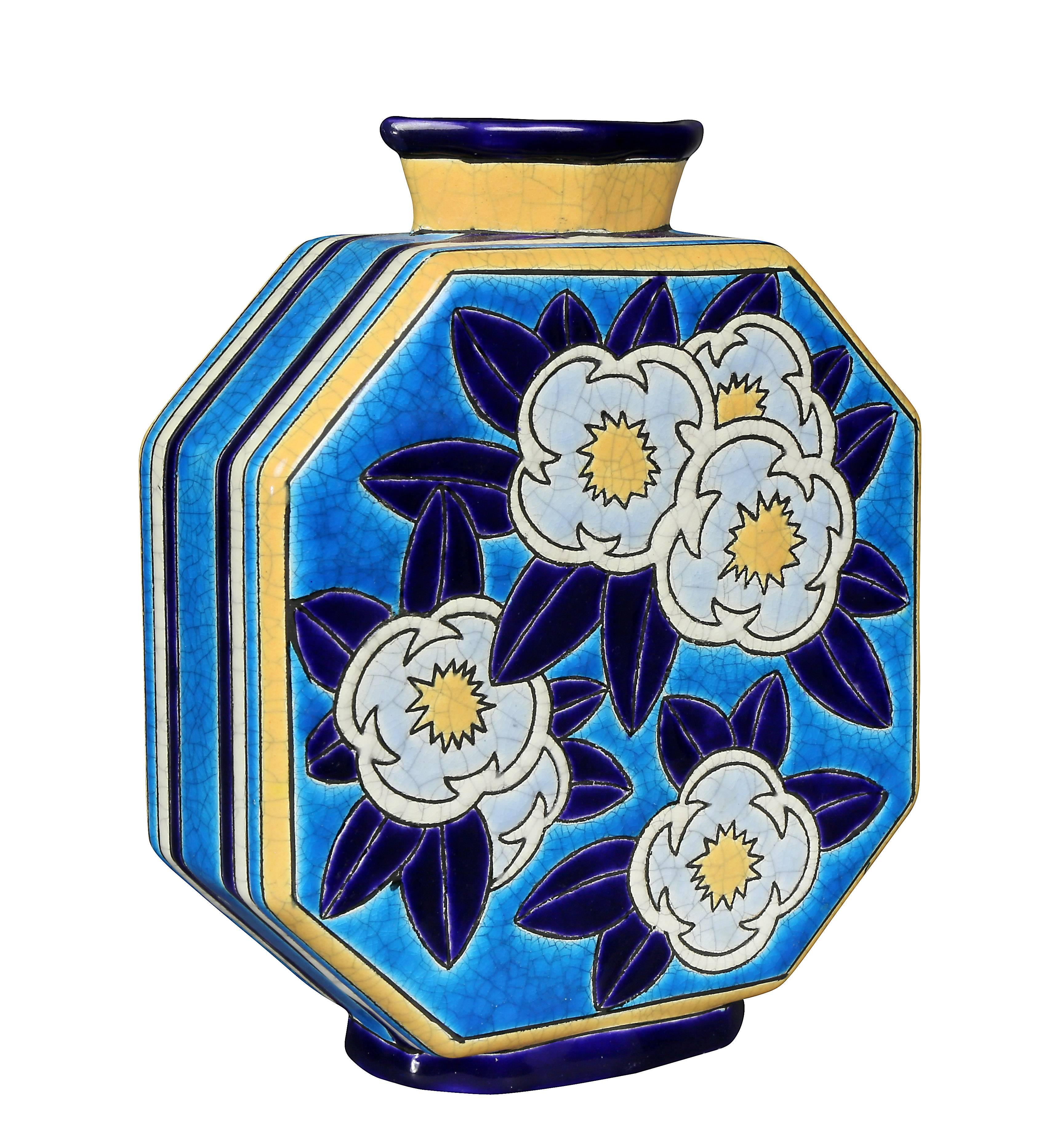 Octagonal flask form decorated in light and dark blue, yellows and white.