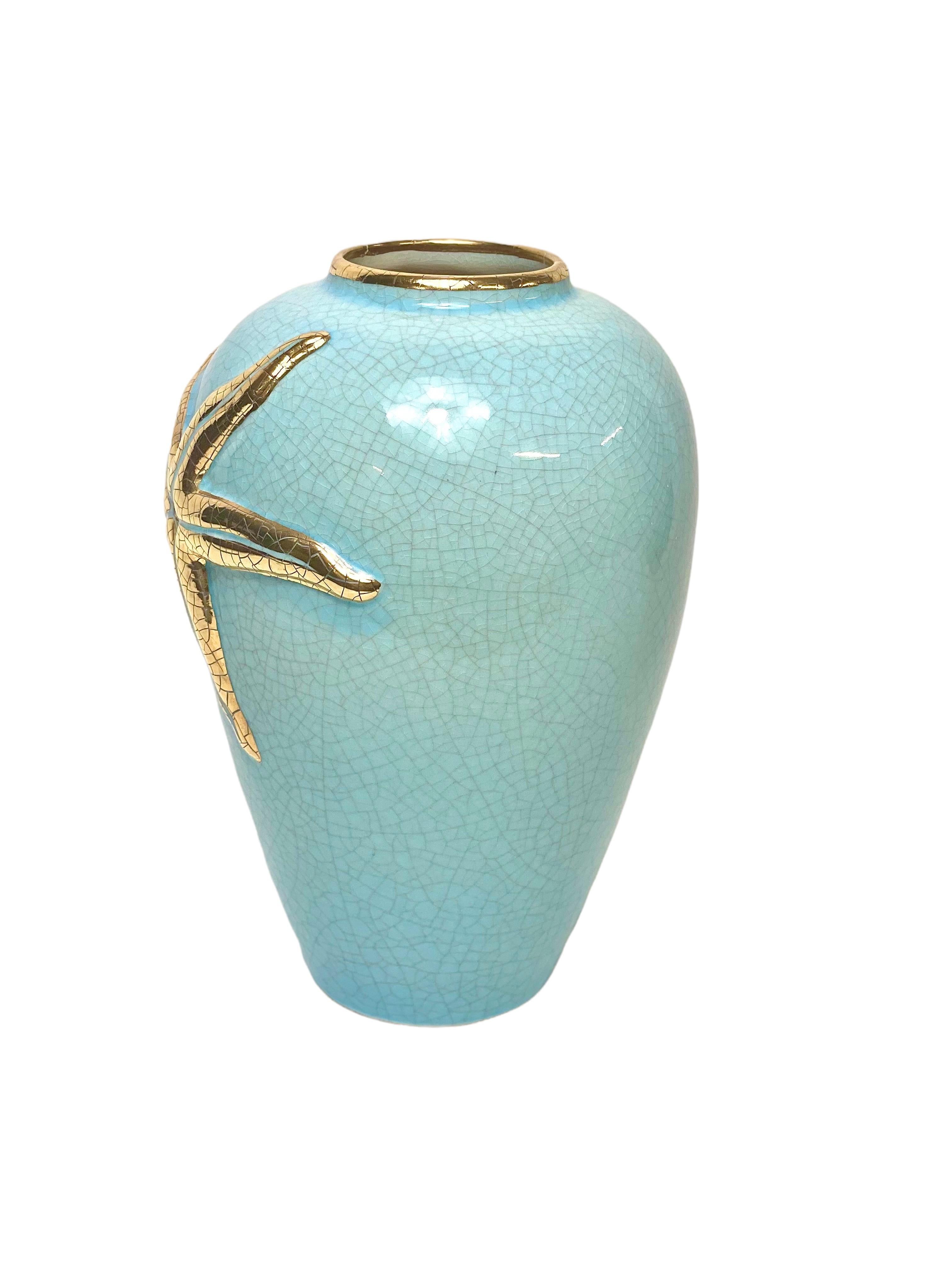 An unusual Longwy enamel decorated vase, in the characteristic colour ‘bleu de Longwy’, and featuring a finely crackled golden starfish splayed over its surface. The Longwy earthenware factory was founded in 1798, and their ceramics became