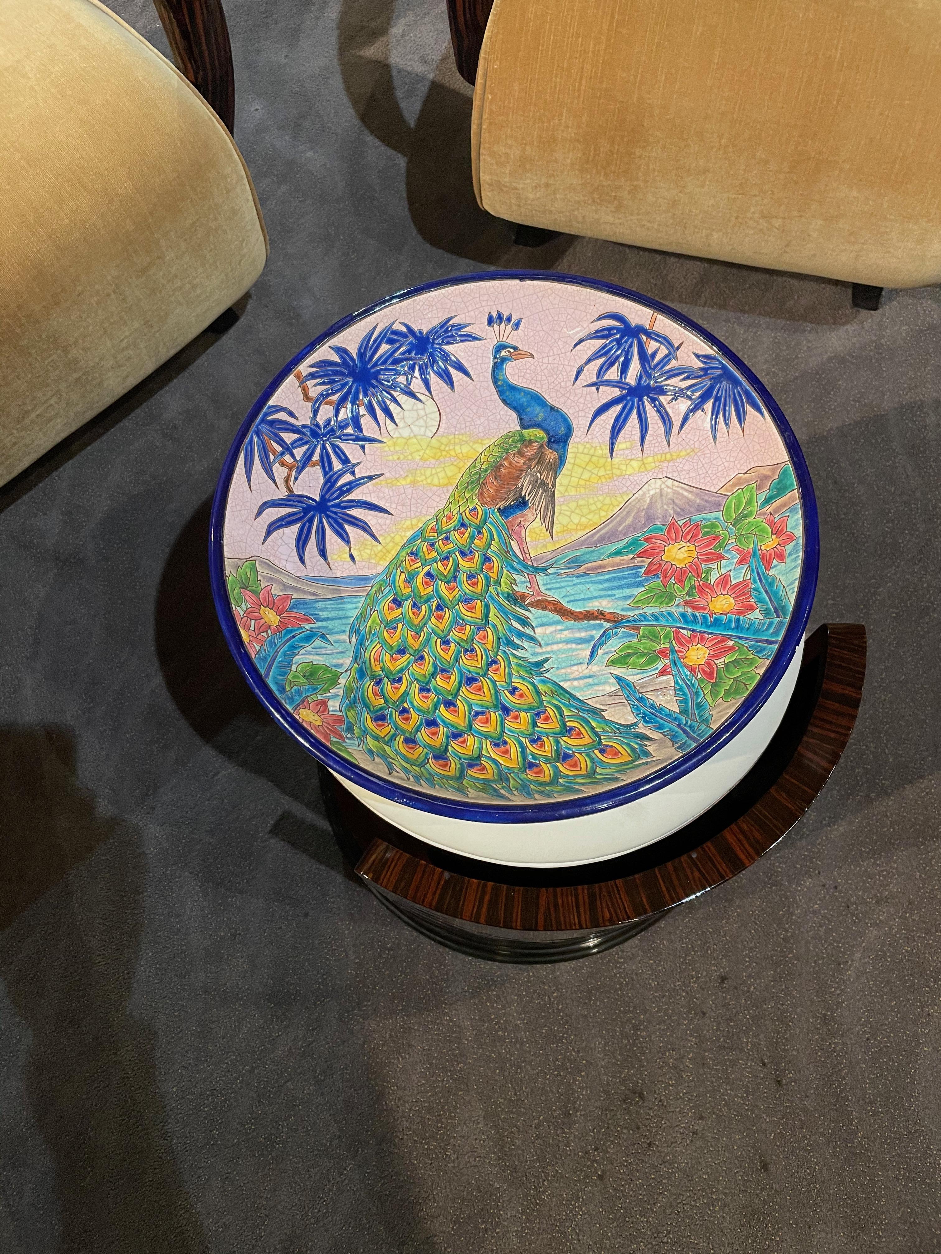 A rare large decorative French deep wall charger by R. Rizzi for Faiences de Longwy de Luneville. Decorated in a crackle glaze of vibrant colors and gilt and enameled with a peacock surrounded by colorful foliage. Craquelle white ground and metallic