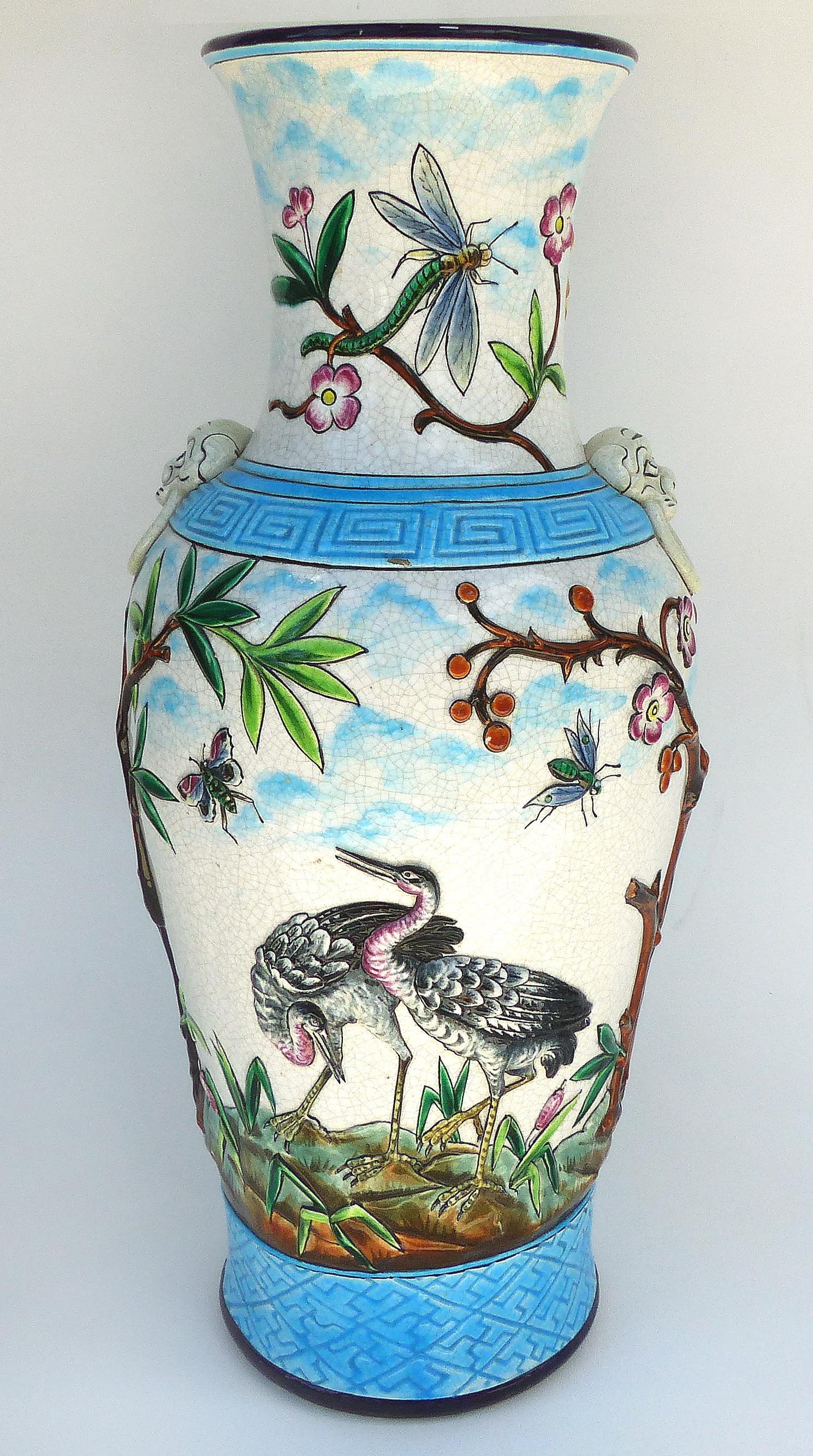 Longwy Enamel Vases in High Relief, circa 1885

Offered for sale is a pair of extremely rare Longwy monumental enameled vases in a chinoiserie style with high relief depicting birds, roosters, butterflies and flying insects. Marked on base as