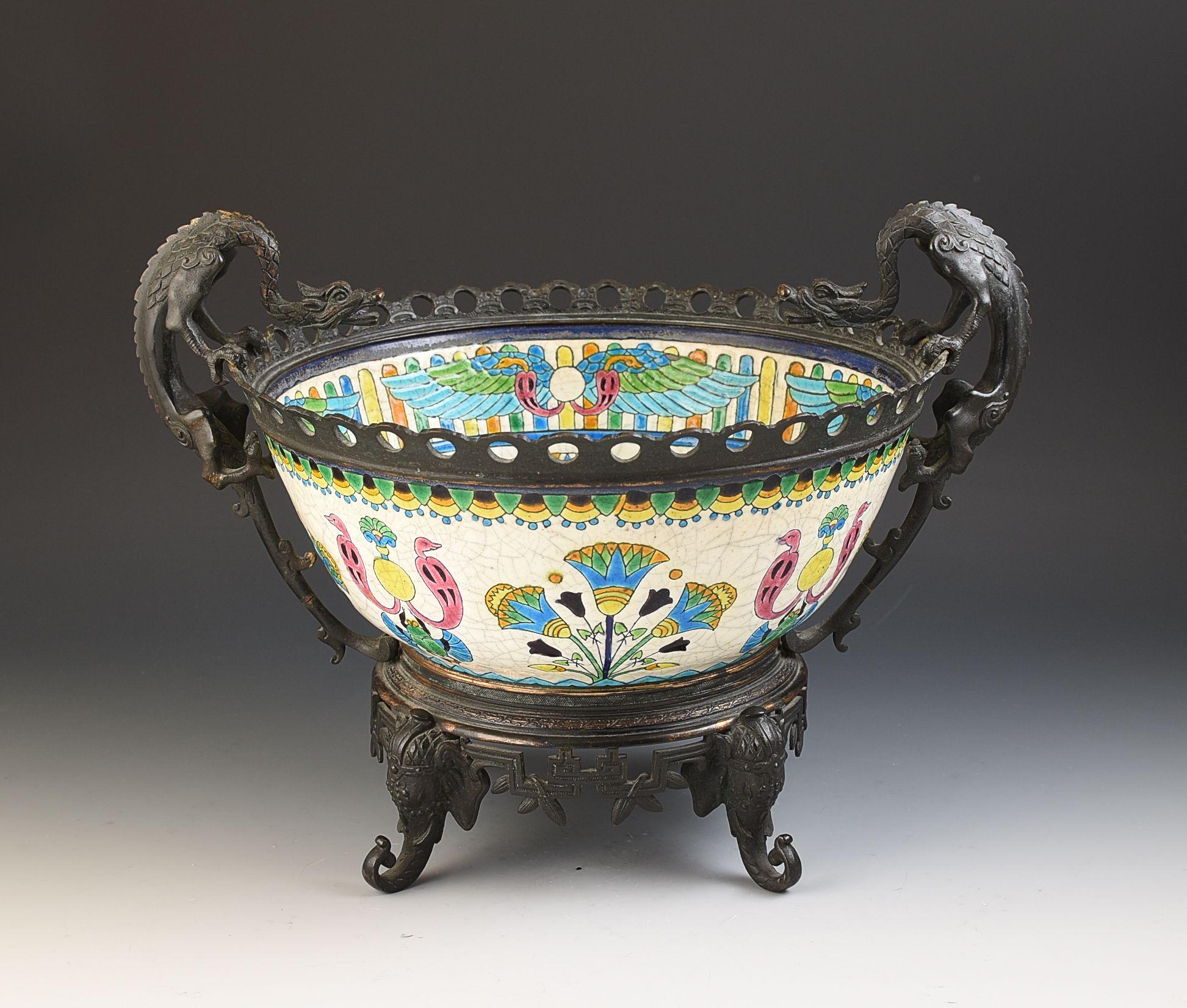 A superb bronze mounted Aethsetic movement decorative bowl dating to the 1880's by Longwy, France. The ceramic is beautifully decorated with the bronze mounts showing dragons as handles and elephants heads as feet. It measures 37cm wide, 1s 27cm