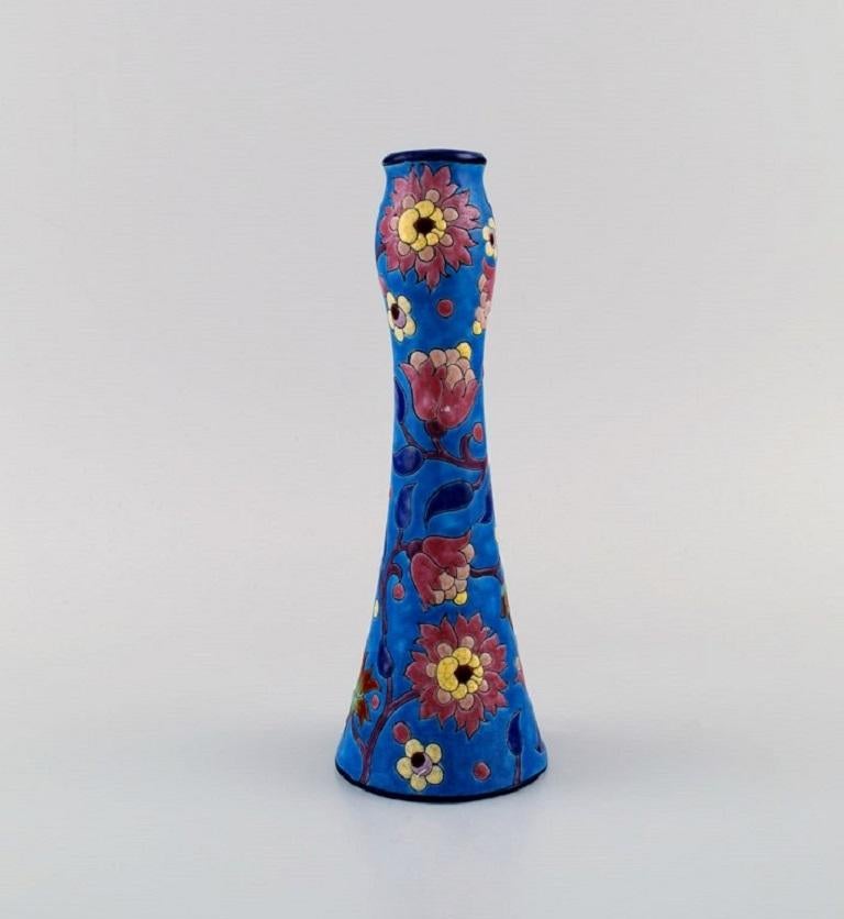 Longwy, France. Art Deco vase in glazed stoneware with hand-painted flowers on a blue background. 
1920s / 30s.
Measures: 20 x 7.2 cm.
In excellent condition.
Stamped.