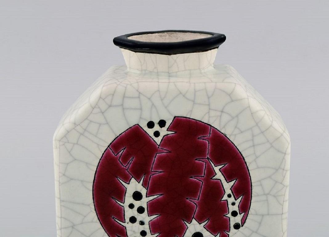 Longwy, France. Art Deco vase in glazed stoneware with hand-painted foliage on a light background. 
Beautiful crackled glaze. 1920s / 30s.
Measures: 17.5 x 14.5 x 5.5 cm.
In excellent condition.
Stamped.

The French town of Longwy, in the