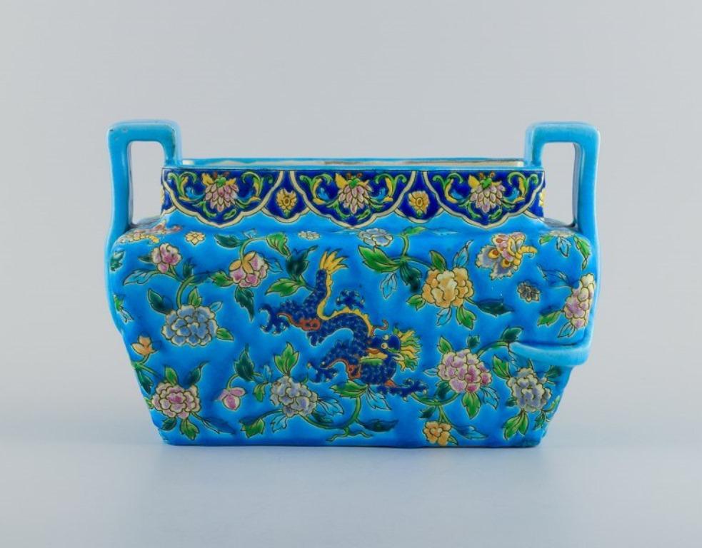 Longwy, France. Large Art Deco jardiniere with handle, azure glaze decorated with flowers.
1920/30s.
Marked.
In excellent condition with natural cracking.
Dimensions: L 32.5 x H 21.0 cm.