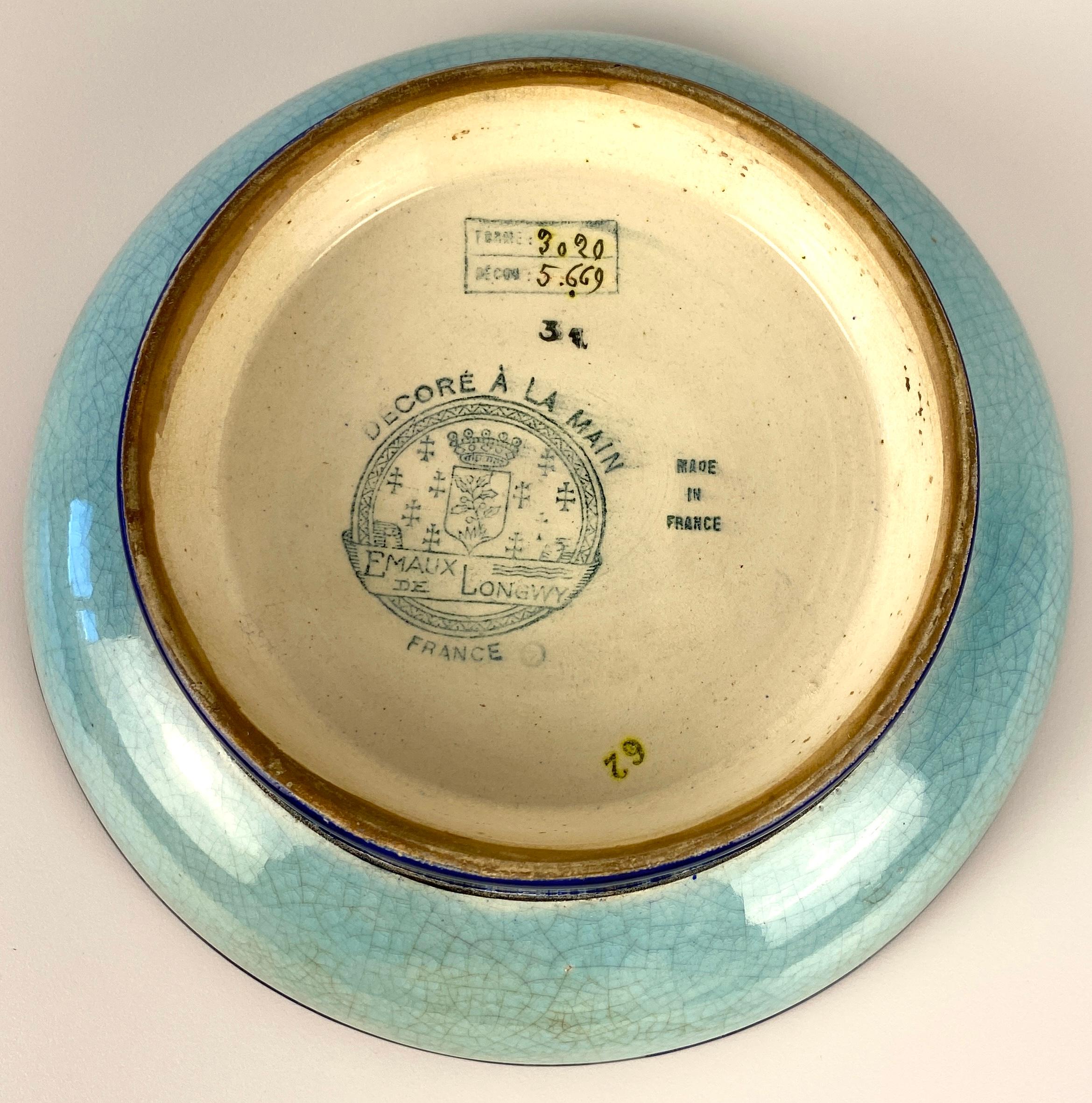 A stunning Art Deco period faience bowl, made in France by the Emaux de Longwy art pottery workshop and dating circa 1920-30s. This earthenware bowl is hand-decorated with Chinoiserie decor and a cloisonné-style enameled glaze.

The decoration