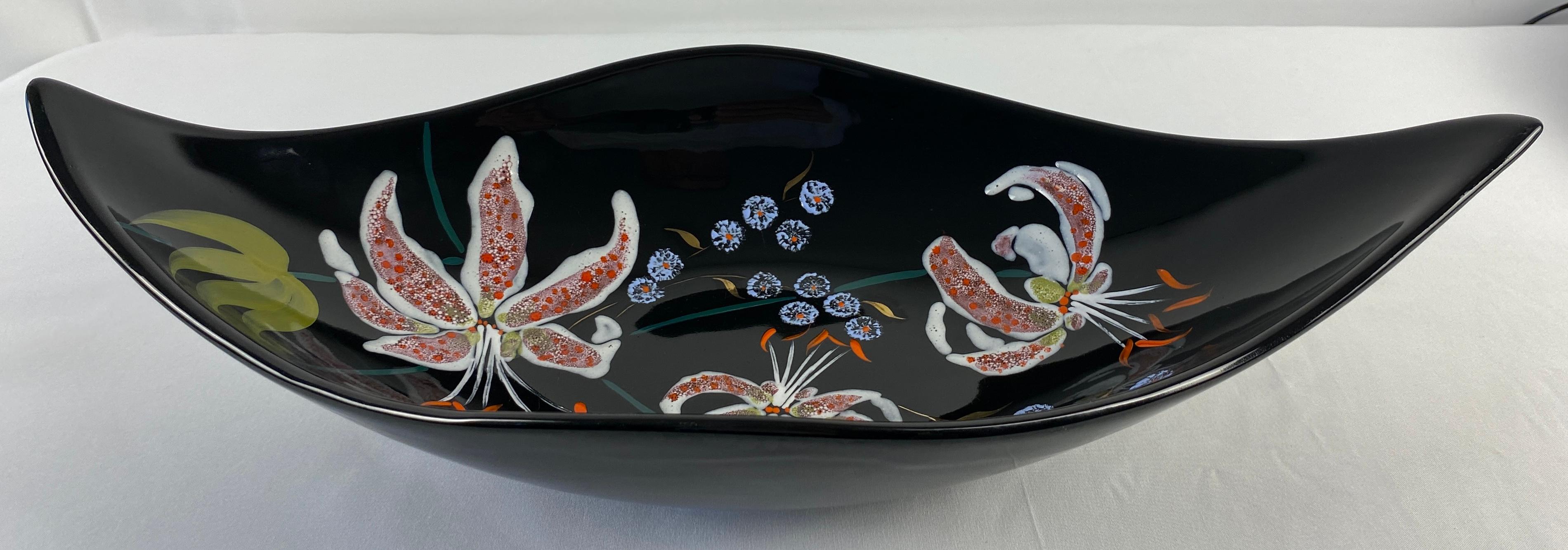 A stunning Mid-Century period faience bowl, made in France by the Emaux de Longwy art pottery workshop. Made and signed by the ceramic artist Lea Valenti. 

The decoration consists of multicolored blossoms with green leaves and blue stems on a