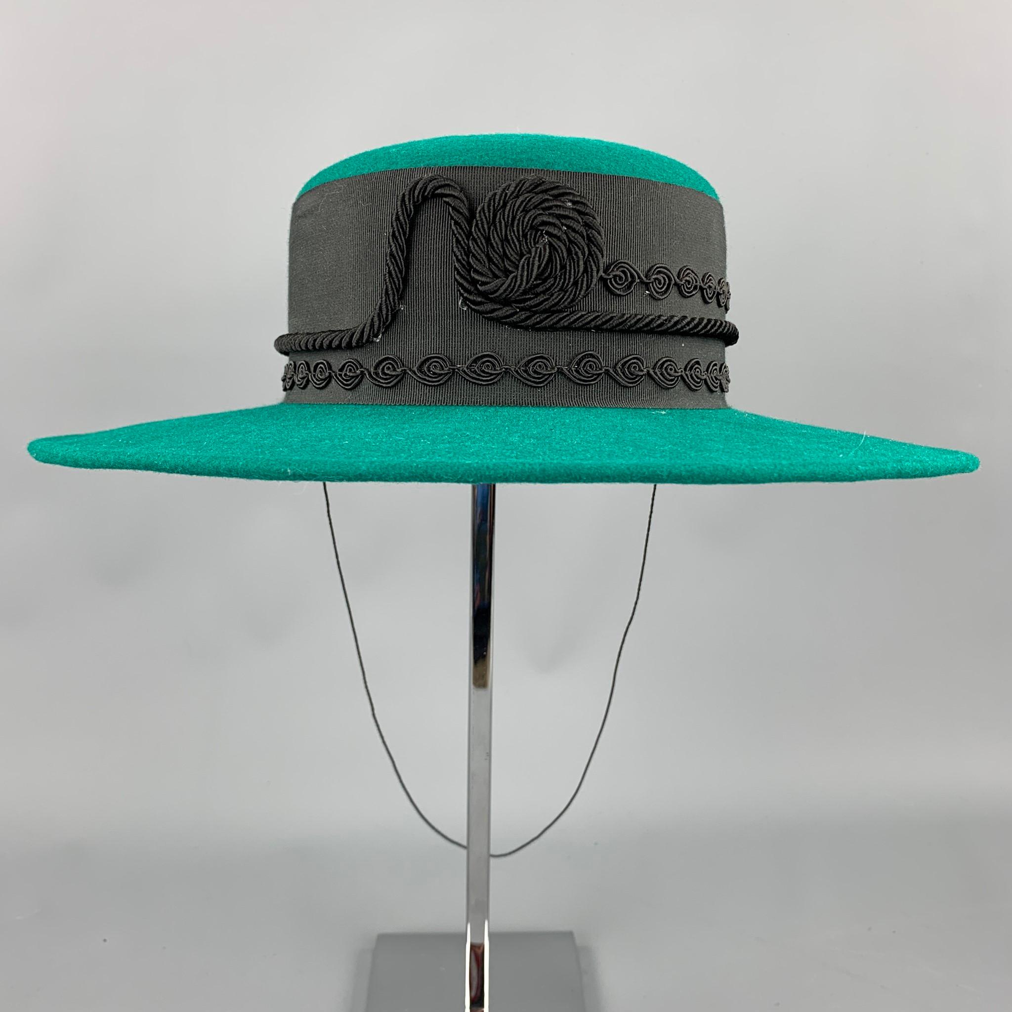 LONNI hat comes in a green wool with a black ribbon trim featuring a drawstring detail. Made in USA.

Very Good Pre-Owned Condition.
Marked: No size marked

Measurements:

Opening: 16 in. 
Brim: 3.5 in. 
Height: 3 in. 

SKU: 95450
Category: