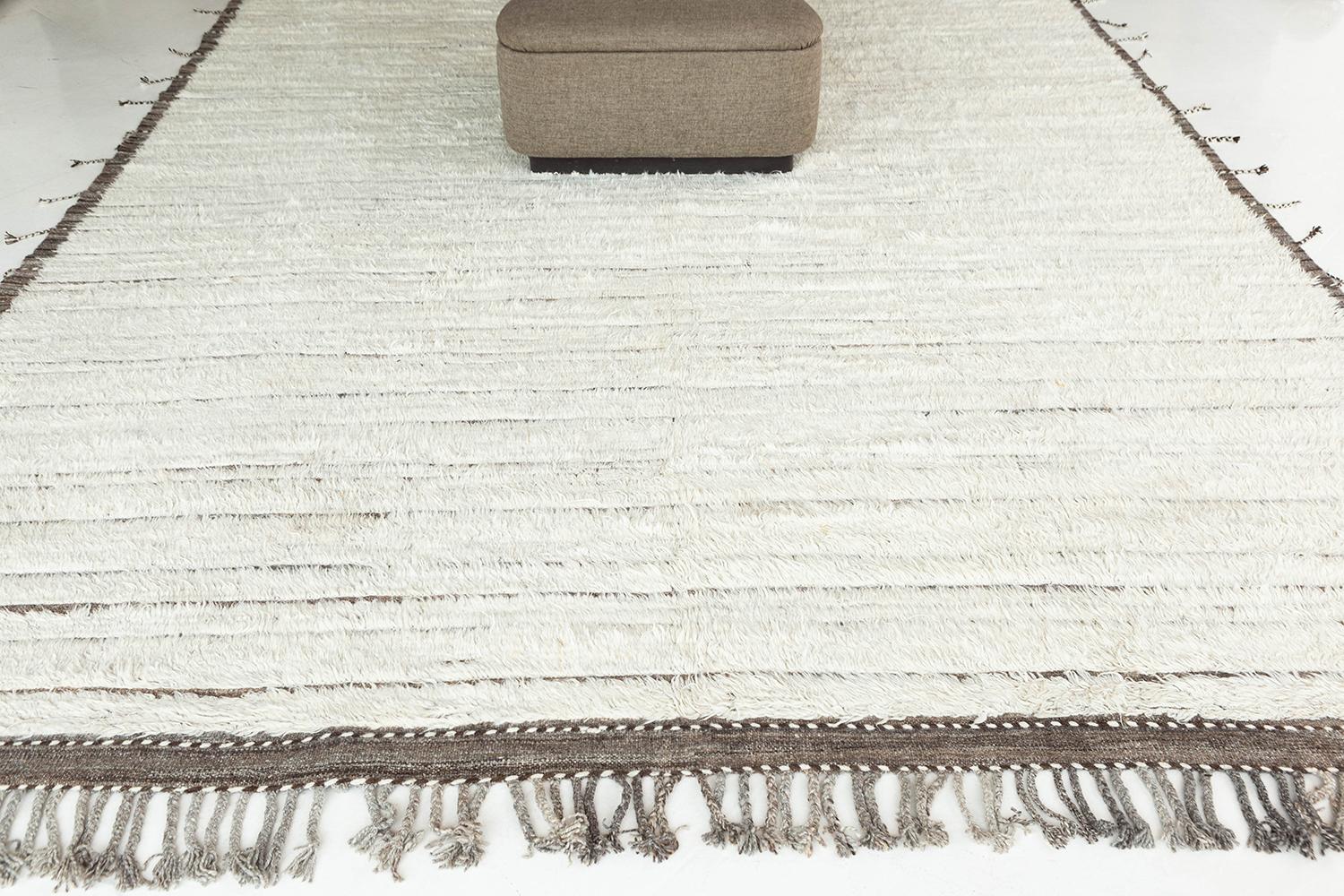 'Loo' is a handwoven luxurious wool rug with timeless embossed detailing. In addition to its neutral earth-toned taupe flat weave, Loo has a beautiful ivory shag that brings a lustrous and contemporary feel to one's space. The Haute Bohemian