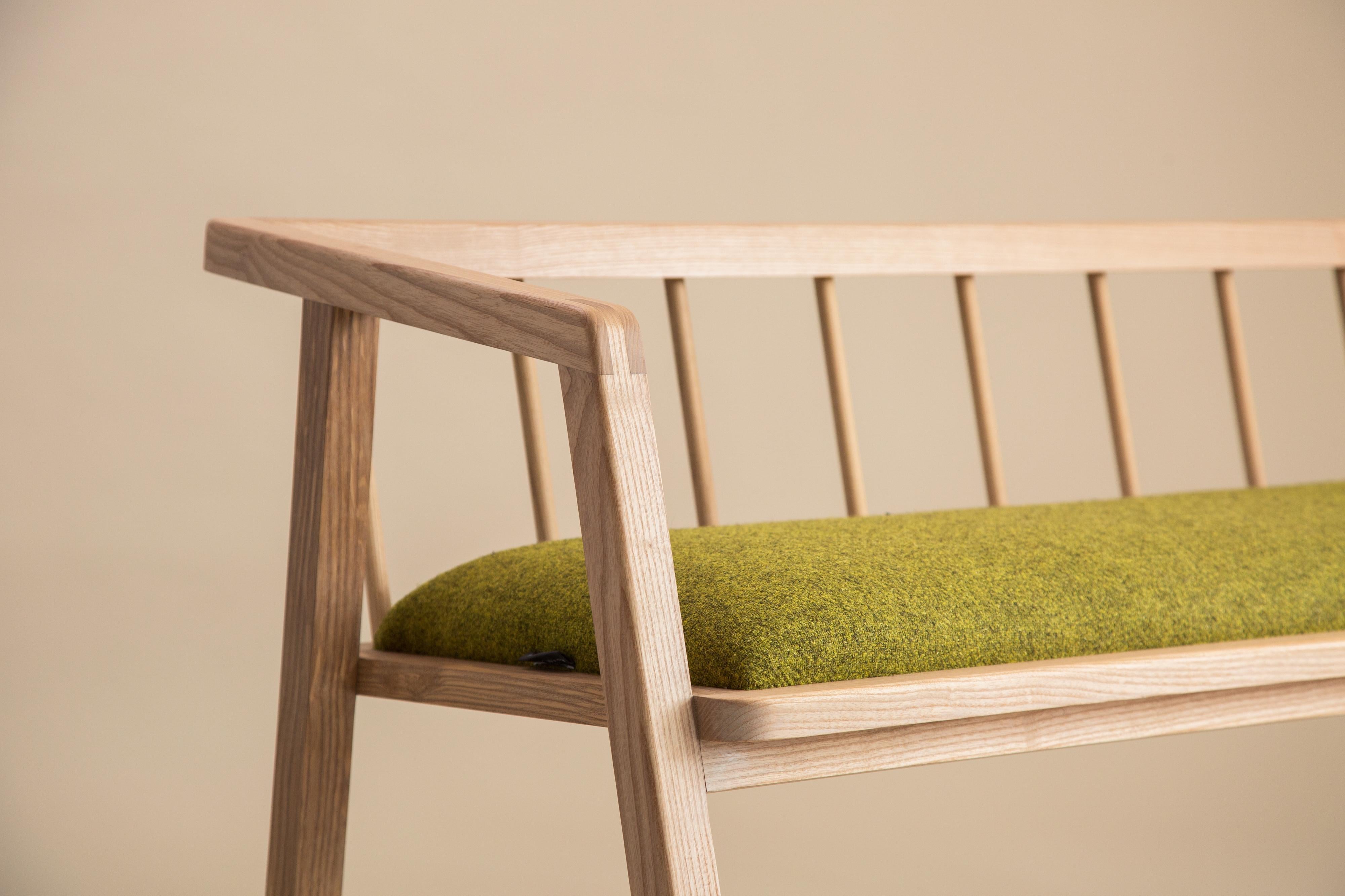 A contemporary two-seater bench, celebrating honest timber construction and native British wood. The framework showcases an upholstered seat using beautiful and sustainable Herdwick wool, from the Lakeland's native sheep breed. 

A clean and simple