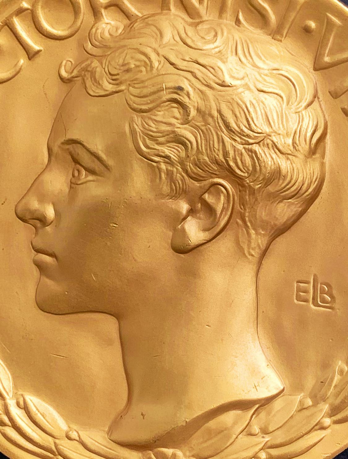 A large and extremely rare example of American bas relief sculpture, this bronze medal plated in gold was sculpted by Evelyn Beatrice Longman for the Loomis Athletic prize sponsored by the Loomis School in Windsor, Connecticut. Longman married the