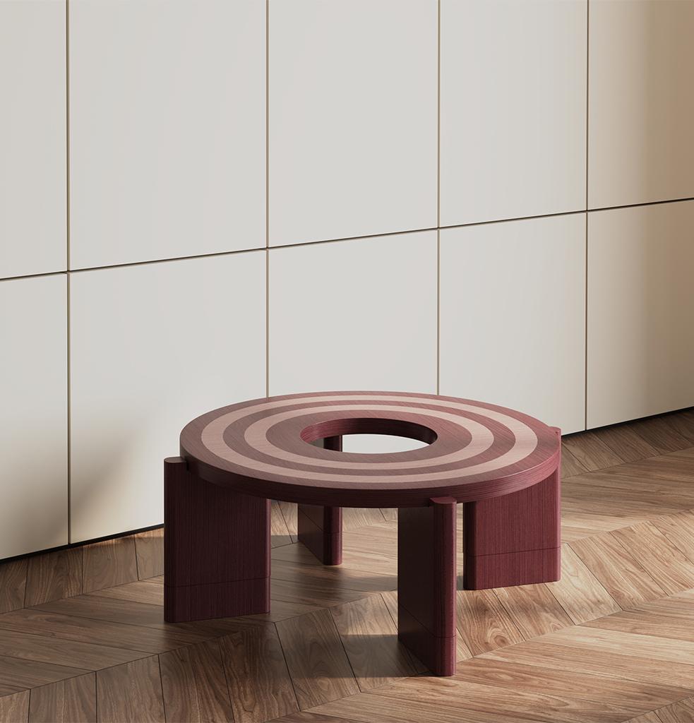 With its circular form and layered composition, the Loop table establishes a central focal point within any space. Crafted using the marquetry technique, two distinct veneers come together on a single surface, creating a graphic pattern that