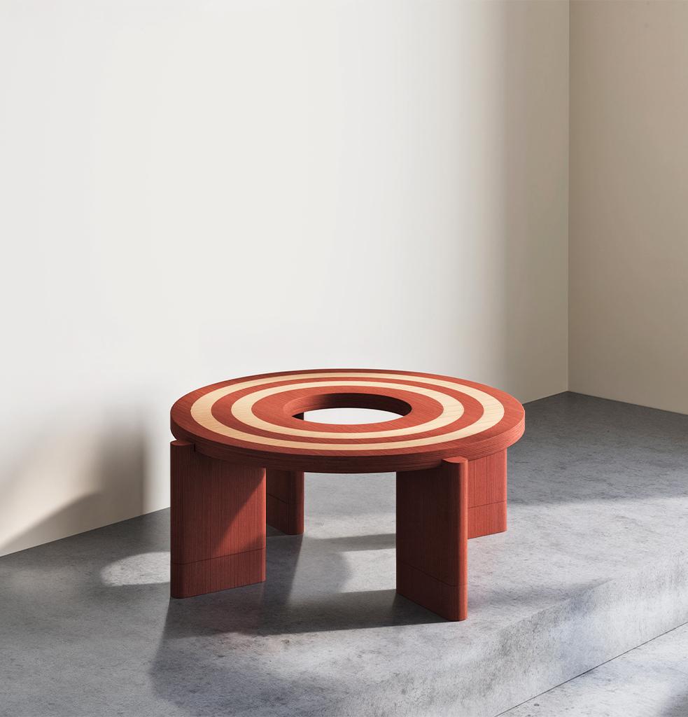 With its circular form and layered composition, the Loop table establishes a central focal point within any space. Crafted using the marquetry technique, two distinct veneers come together on a single surface, creating a graphic pattern that