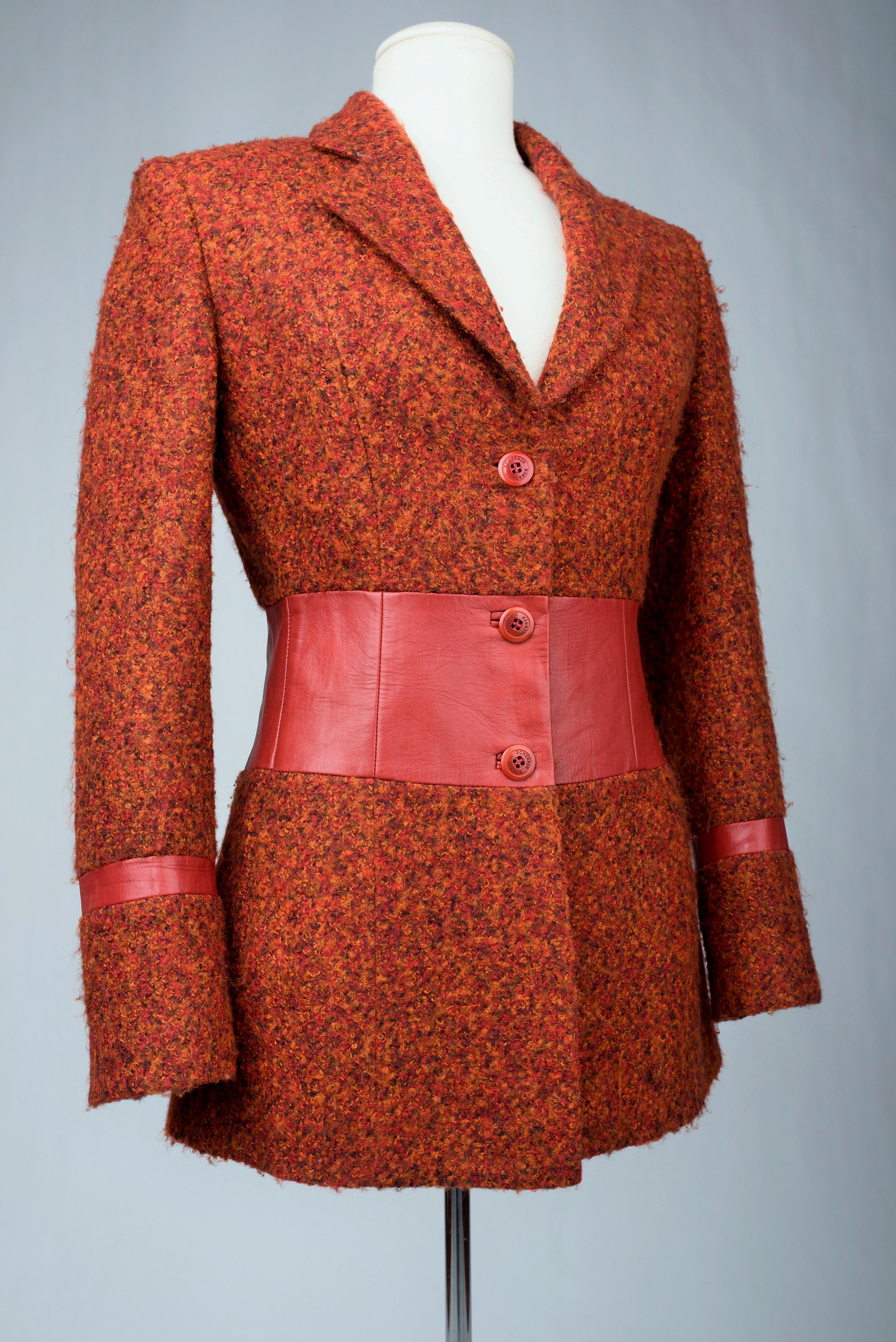 Circa 2000 - 2010

France

Beautiful blazer jacket in mottled wool with a blood red leather band, from the Cuir collection of the Maison Jean-Louis Scherrer dating from 2000. Fitted jacket with two side slit pockets and real leather appliqué