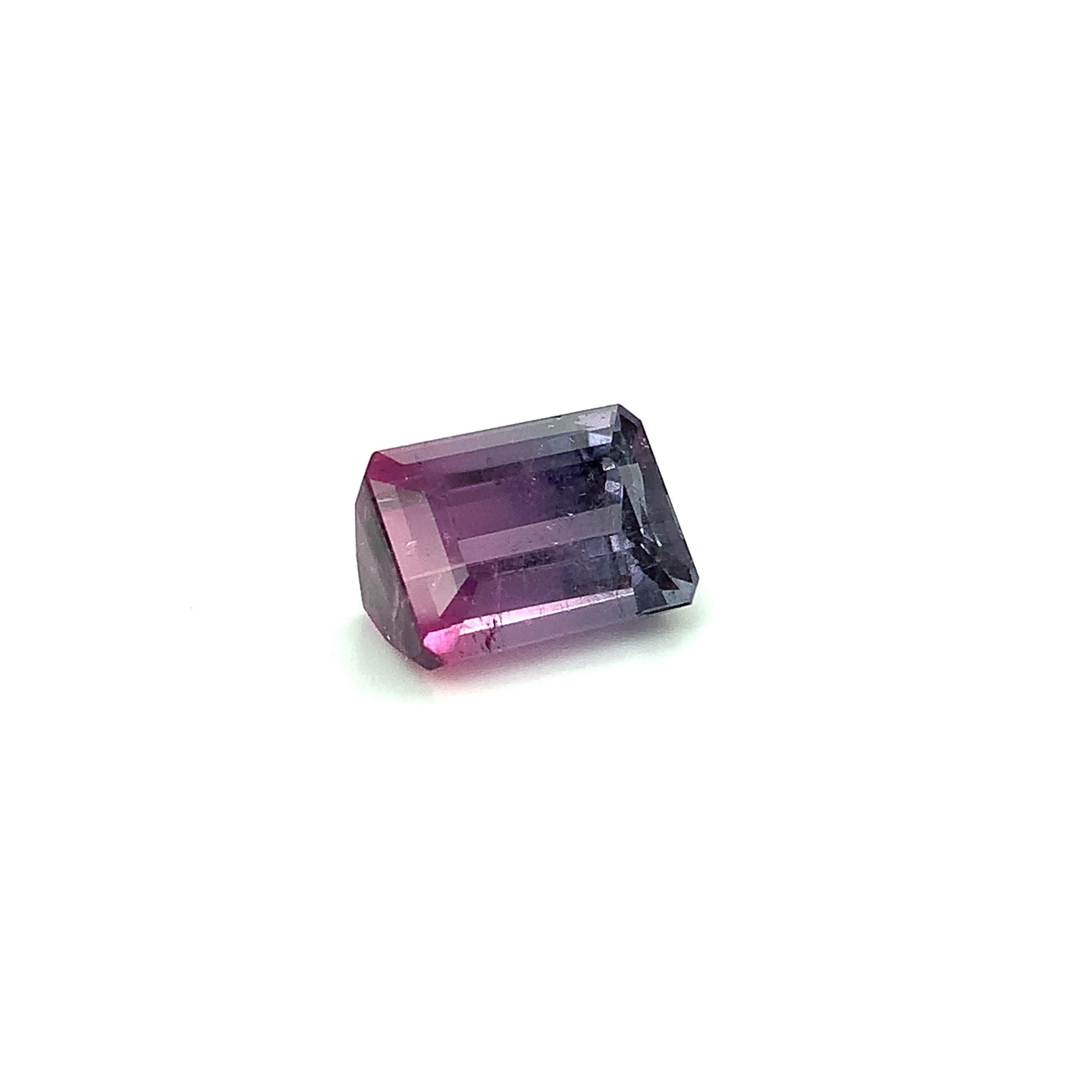 Tourmaline occurs in all colors of the rainbow, but purple tourmaline is quite unusual, especially in clean medium purple hues. This crystalline parti-color purple and pink tourmaline emerald-cut exhibits a beautiful ombre effect of colors,