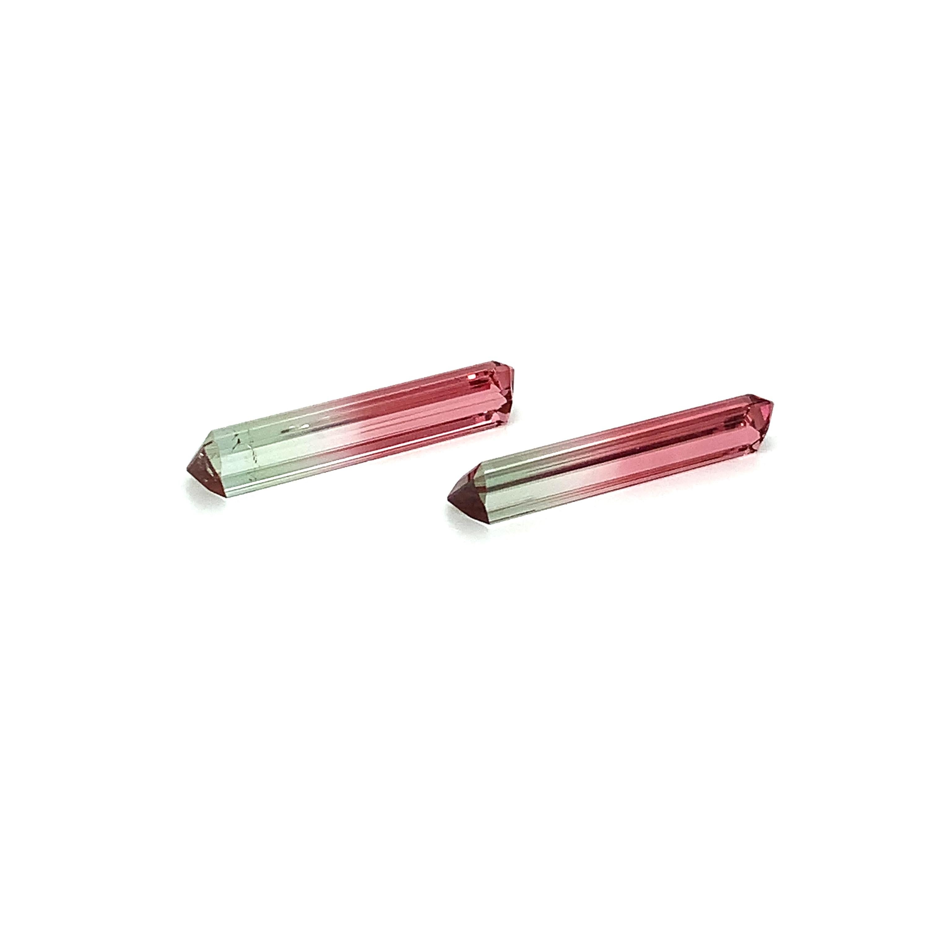 This beautiful matched pair of elongated bi-color tourmaline have a stunning division of classic watermelon tourmaline colors. Extremely brilliant, clean and full of life, these gems exhibit a lovely shade of green on one end, blending into a