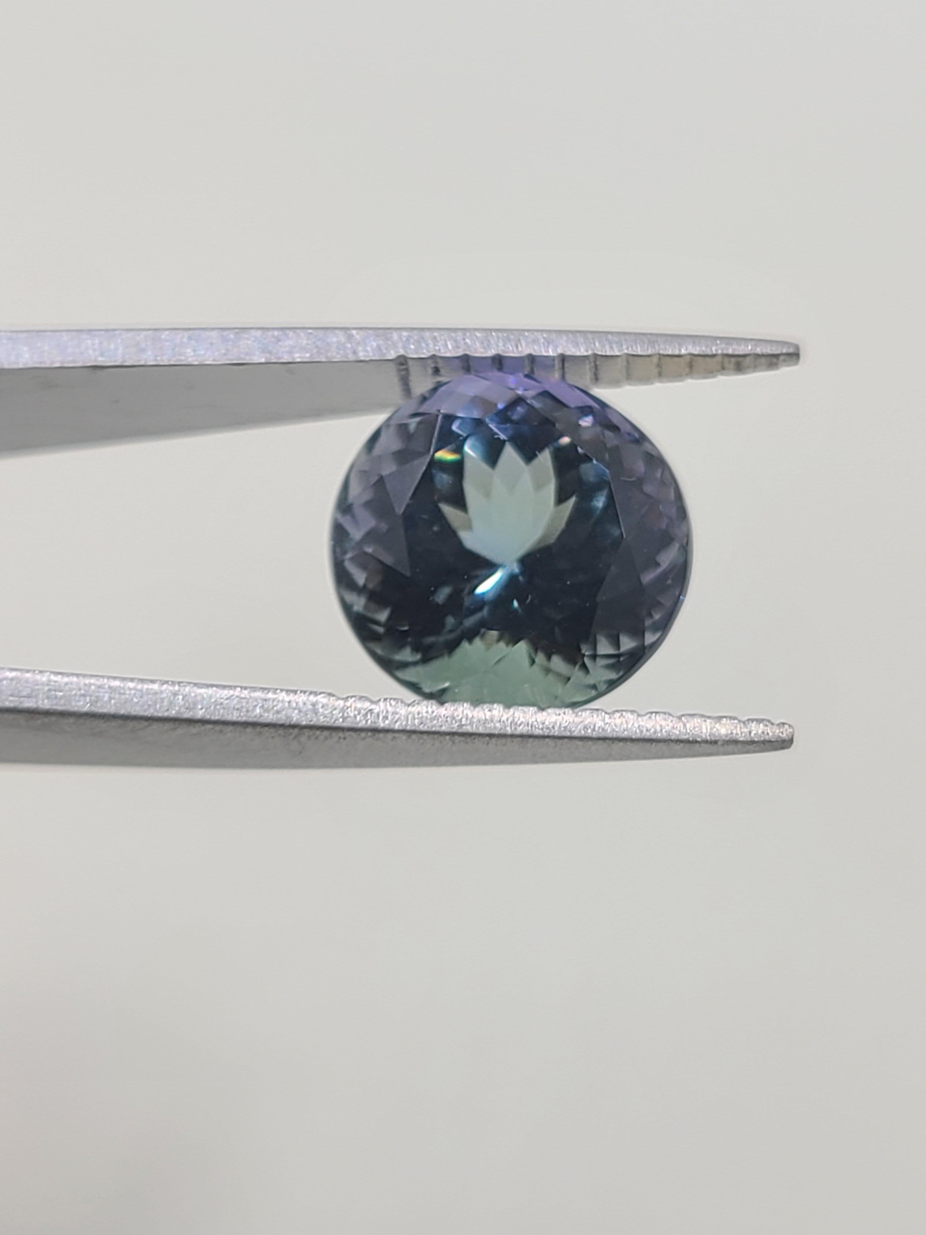 This loose tanzanite measures 10mm in diameter by 7.20mm in depth with a round faceted cut, giving it a good symmetry as it displays its breathtaking shade.

This beautiful tanzanite exhibits purple, blue, and blue-green, marketed at ocean tanzanite