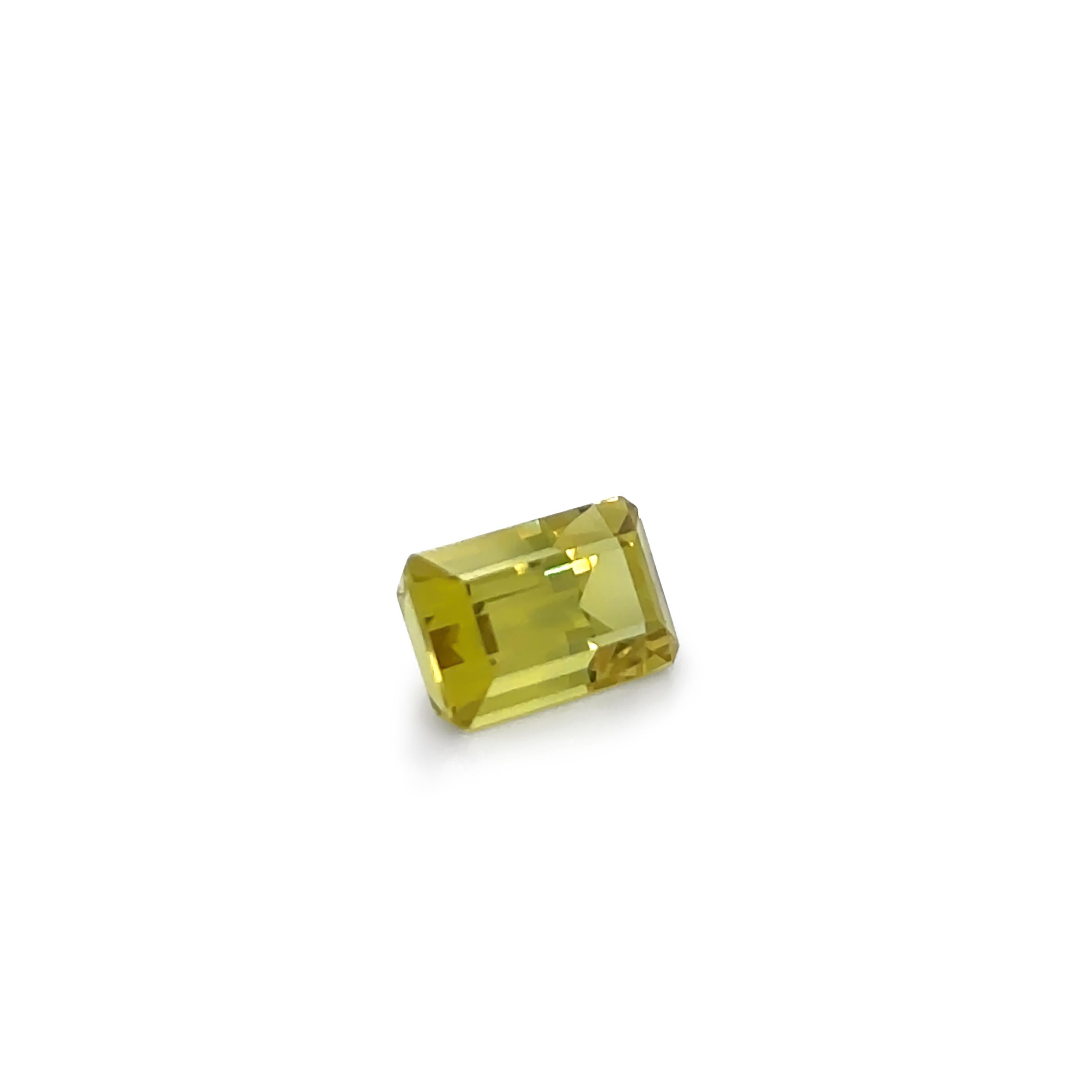 This exquisite natural yellow sapphire, weighing 3.27ct, is expertly cut in an emerald rectangular mixed cut, showcasing a bright yellow hue with exceptional transparency and brilliance. Measuring 9.54 x 5.76 x 5.29mm, this faceted gemstone is a