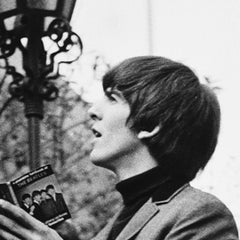 The Beatles, George Harrison signing a book in the walled garden