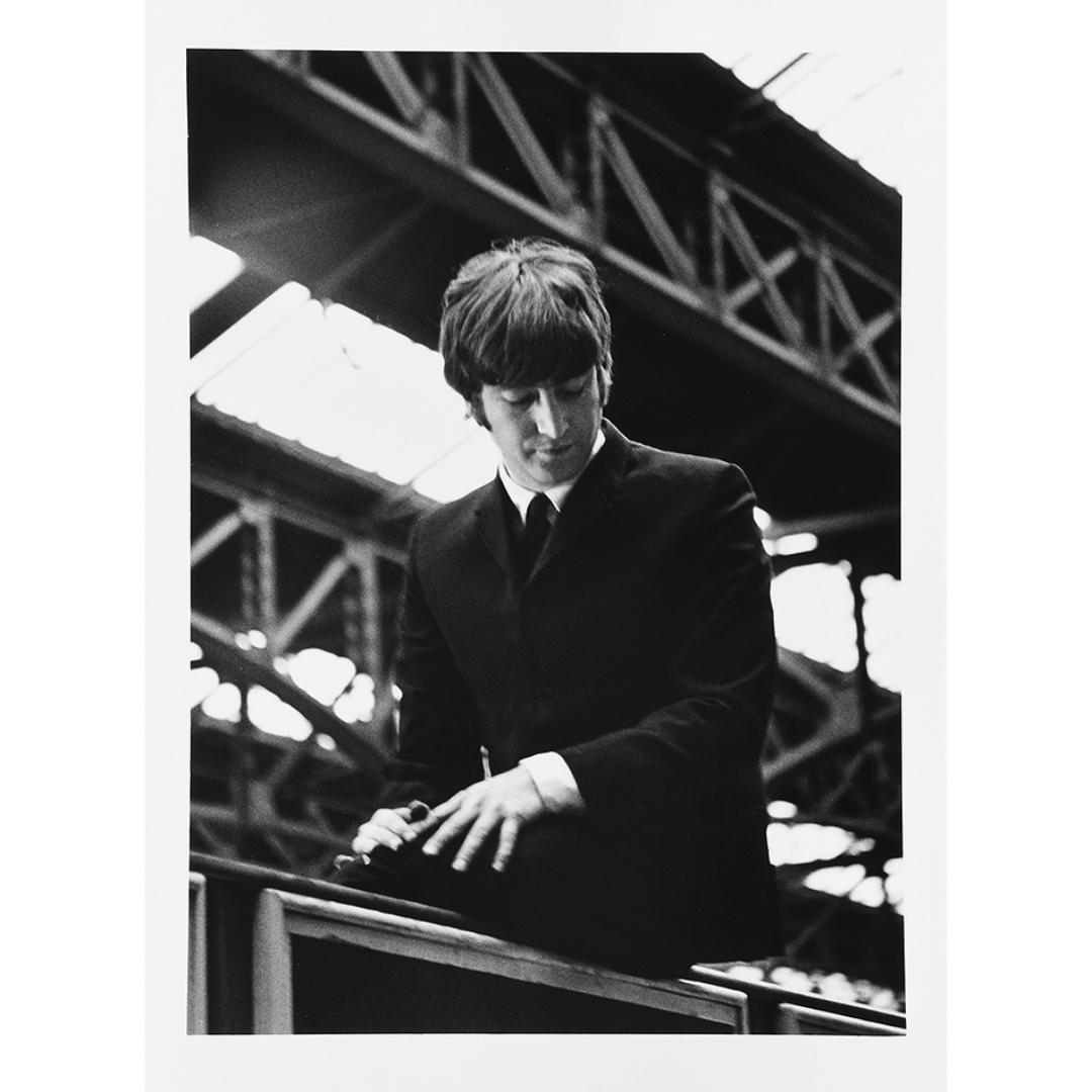 Lord Christopher Thynne Portrait Print - The Beatles, John Lennon sitting on an advertising hoarding I