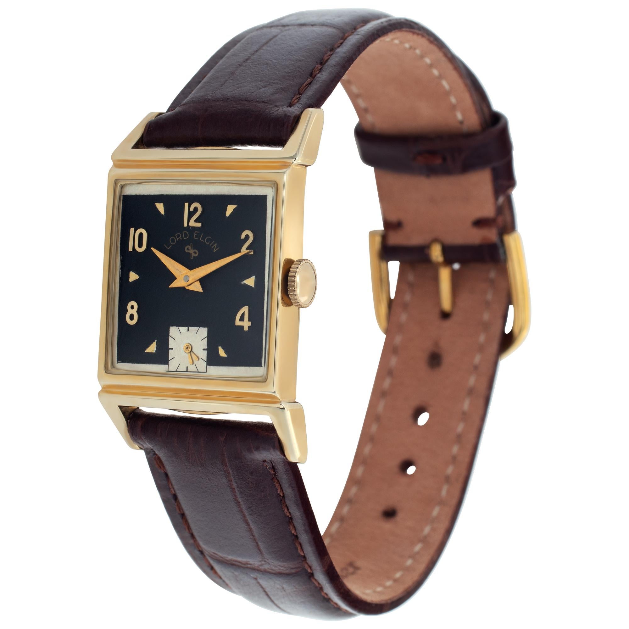 Lord Elgin Classic watch with two-tone black and silver dial in 14k yellow gold on brown leather strap.17 jewels. Manual with sub-seconds. Ref 4531. Circa 1948. Fine Pre-owned Lord Elgin Watch. Certified preowned Vintage Lord Elgin Classic 4531