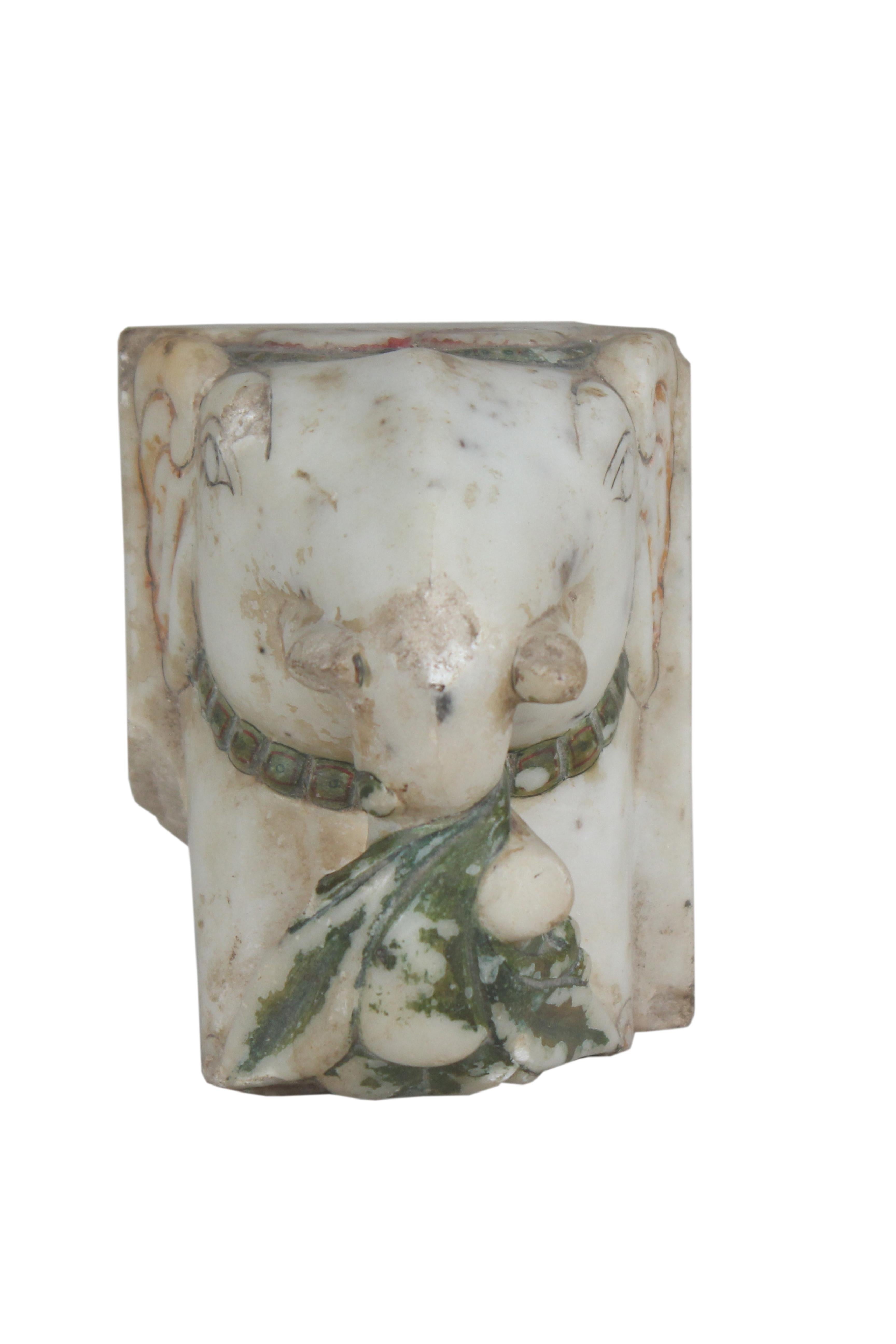 A lovely, old white marble Ganesh head with traces of the original paint. It is a fragment of larger piece with great patina, India, early 20th century. Everyone loves Ganesh--the remover of obstacles. Put him near your doorway.