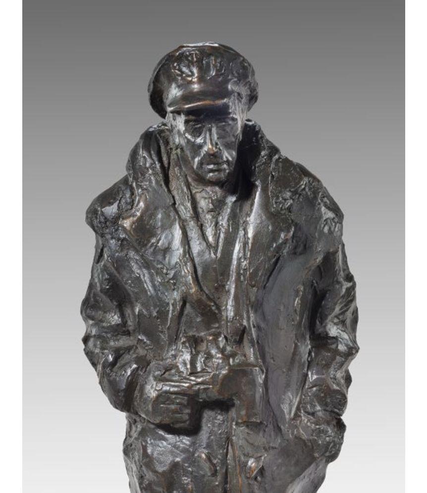 This bronze is the maquette for a sculpture of Lord Louis Mountbatten wearing a naval duffel coat, peaked cap and sea boots and holding a pair of binoculars. It is set on a highly polished black stone base and inscribed on the back ‘Mountbatten