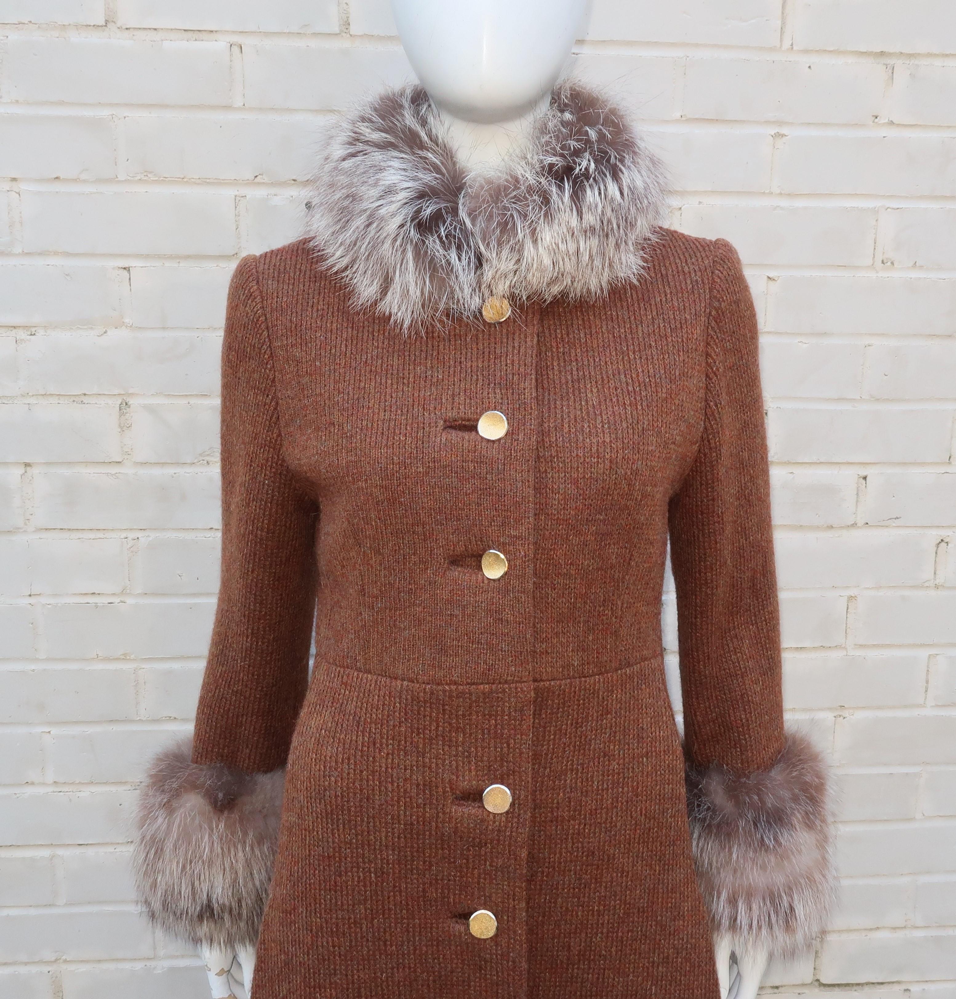 Lord & Taylor's 1960's mod version of a princess coat in a comfortable mohair blend wool knit with glamorous fox fur trim.  The body of the coat is an autumnal rust colored brown wool knit in an elongated princess cut which buttons and snaps up the