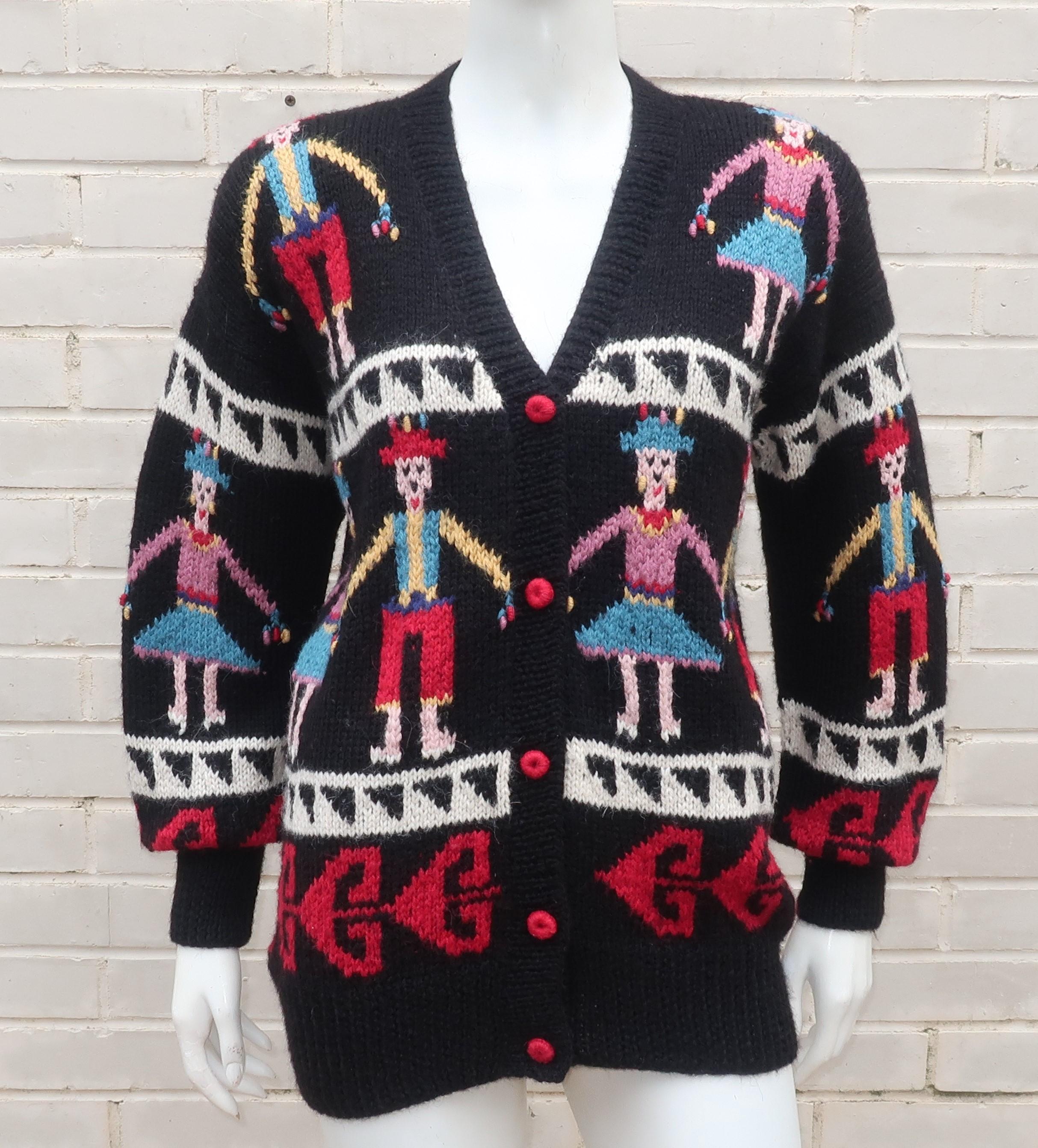 Charming Peruvian hand knit cardigan sweater for Lord & Taylor with folkloric style figures in traditional attire.  The black body of the sweater is accented by vibrant shades of red, yellow, blue, mauve and pink.  The shoulders are enhanced by
