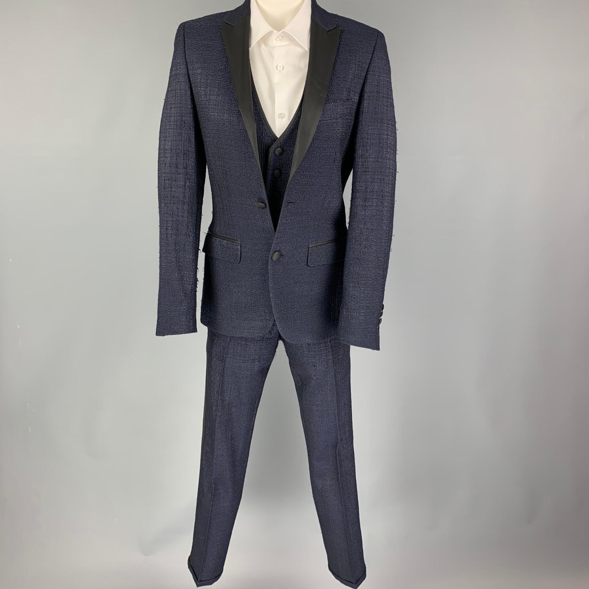 LORDS & FOOLS 3 Piece Tuxedo suit comes in a navy & black textured wool blend with a full liner and includes a single breasted, double button sport coat with a peak lapel and a matching vest & flat front trousers.

Excellent Pre-Owned