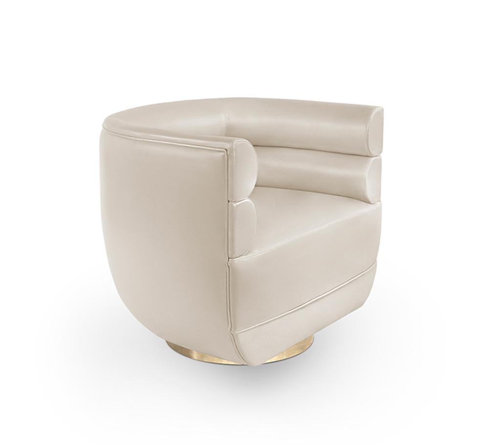 Inspired by the midcentury retro designs, Loren armchair has a swivel golden brass base and it is upholstered in a leather. Due to its low back, it can be used both as a club chair or a living room chair. The compact and curved look, along with its