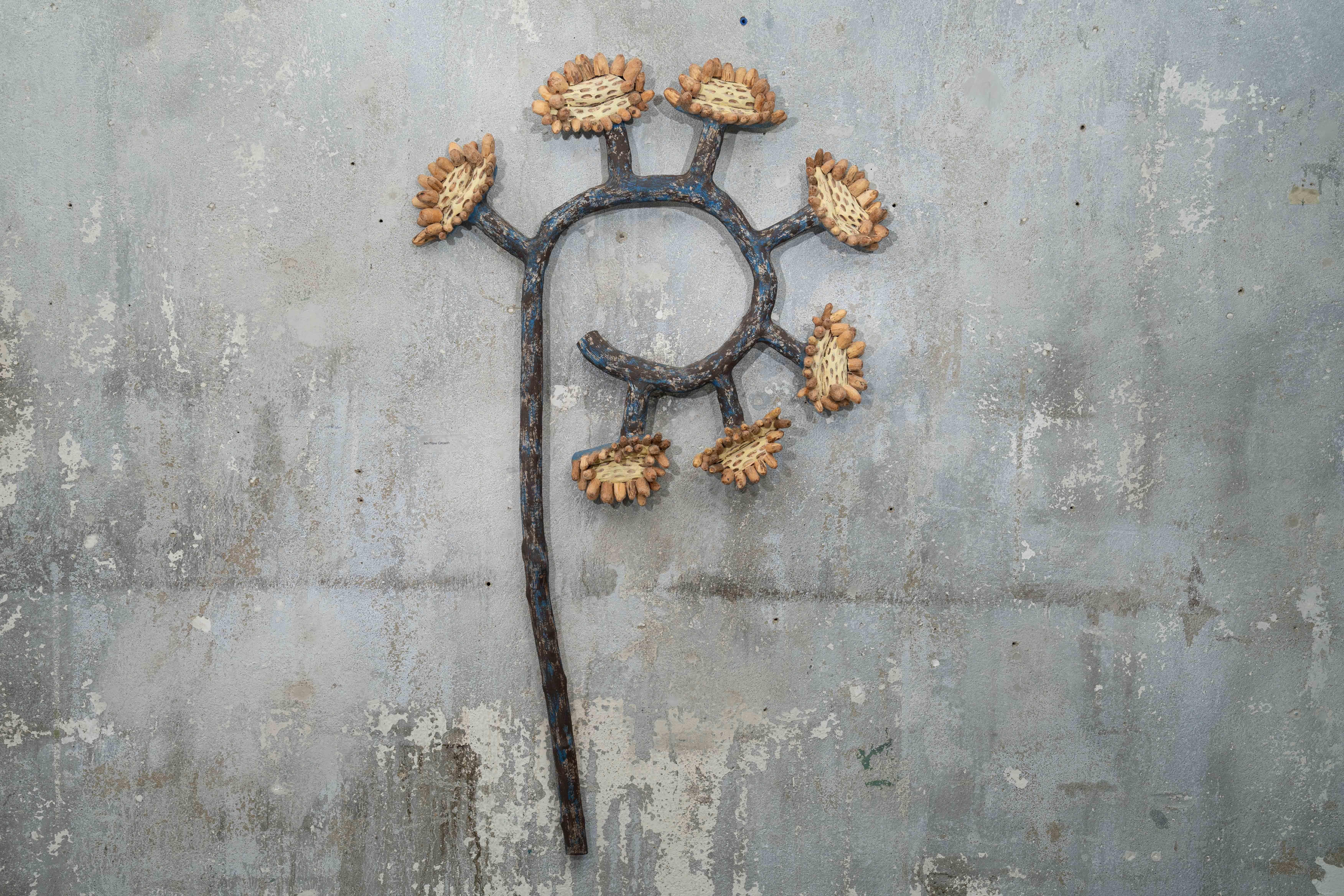 Wall sculpture of sunflower plant: "46r New Growth"