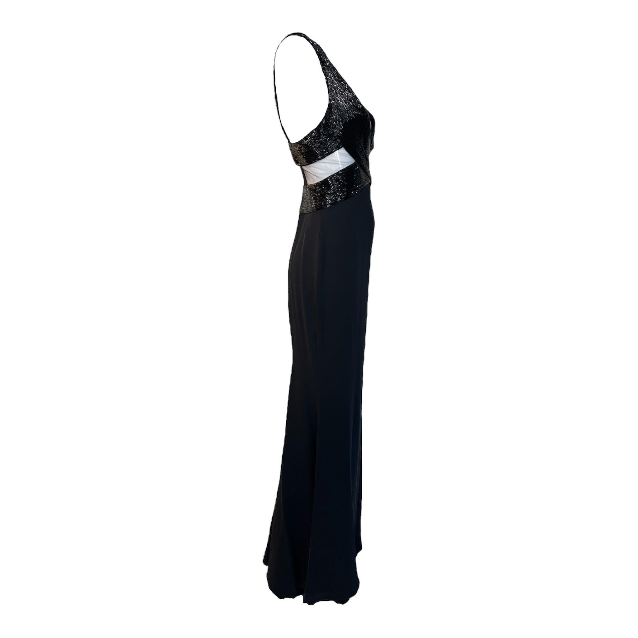 Show-stopping evening gown by Lorena Sarbu. Heavily beaded bodice with peek-a-boo mesh panels at ribs and lower back, creating a very compelling silhouette. Sexy plunging V-neckline and low back. Back zip closure. Lined Skirt. Excellent condition.