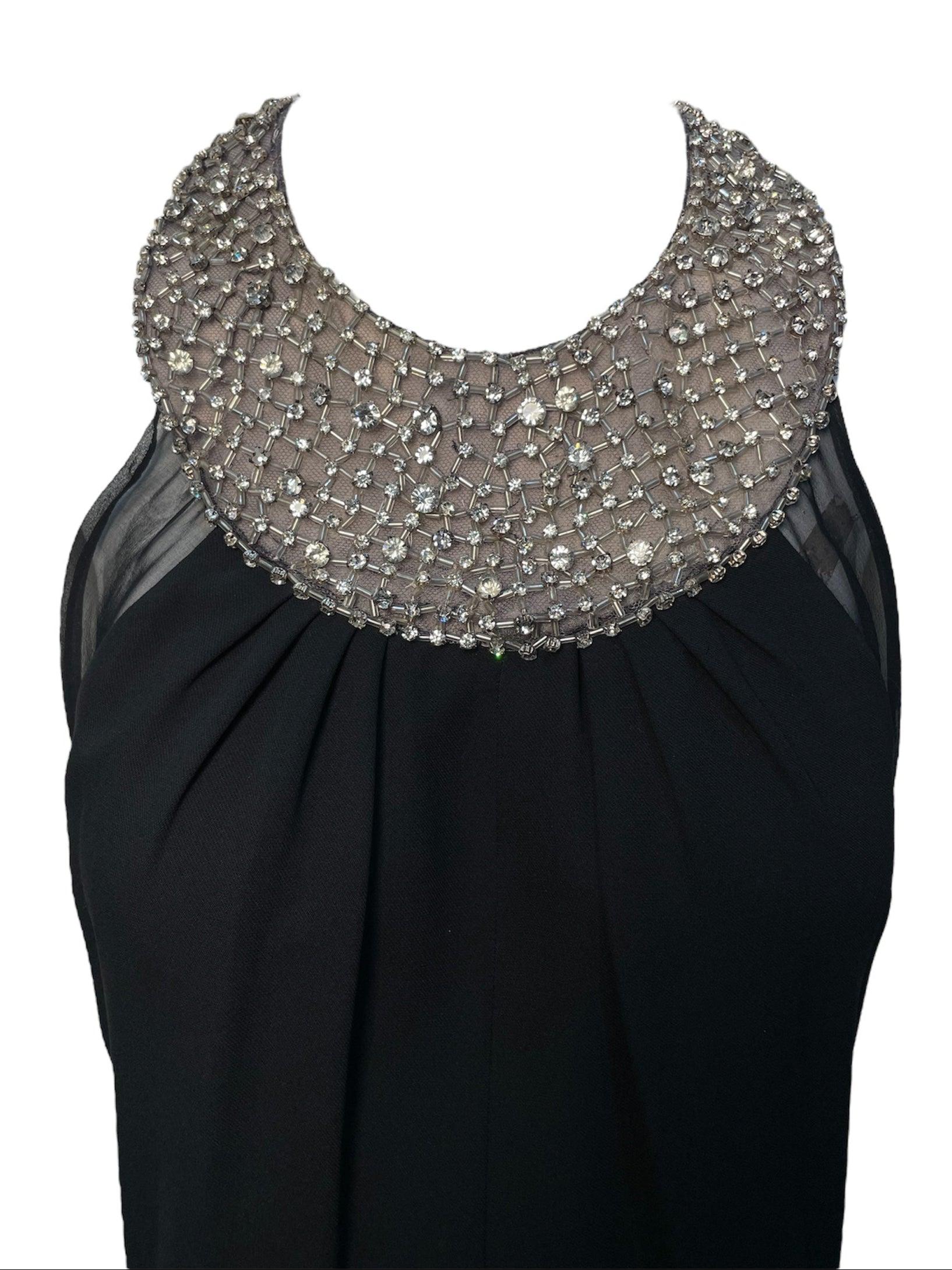 Lorena Sarbu's Rhinestone Regency High Neck Gown.  High neck design is studded with sparkling rhinestones, evoking the sophistication of icons like Audrey Hepburn. Semi-open back and sheer silk panel with a front slit skirt. Excellent condition.