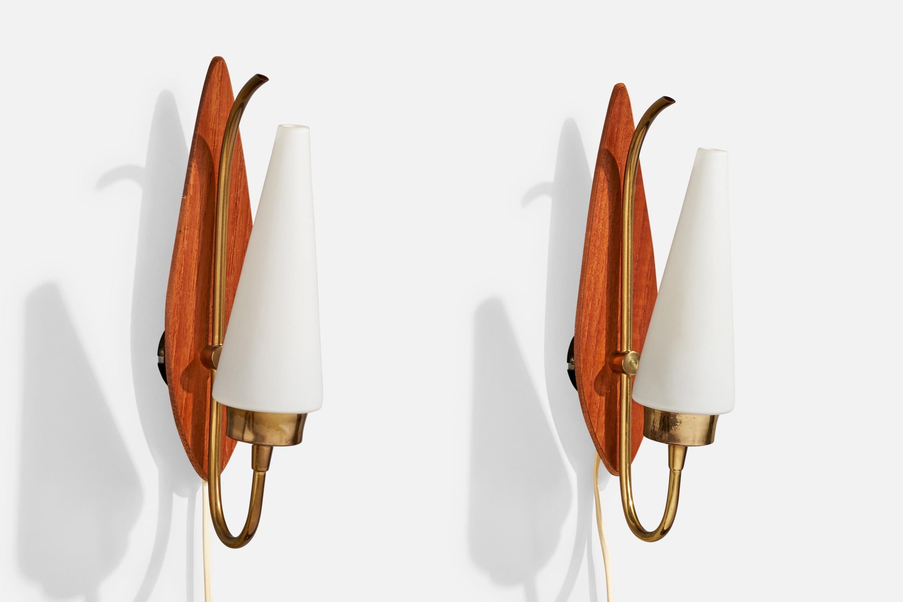 A pair of teak, brass and opaline glass wall lights produced by Lorentzons, Sweden, 1950s.

Overall Dimensions (Inches): 12” H x 2.75” W x 5.2“ D

Back Plate Dimensions (Inches): 2.25” H x 2.25” W x .65” D

Bulb Specifications: E-14

Number of