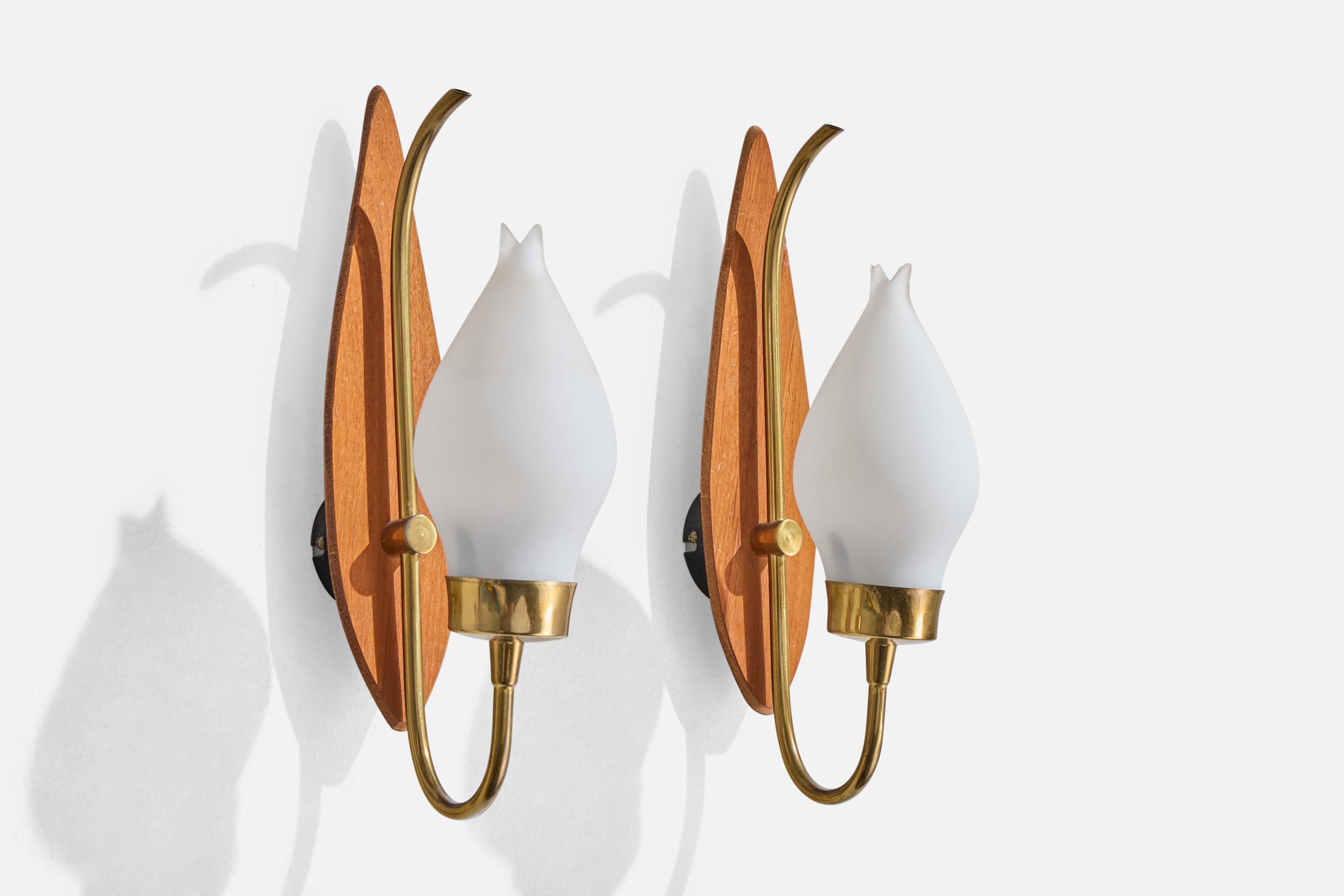 A pair of teak, brass and opaline glass wall lights produced by Lorentzons, Sweden, 1950s.

Overall Dimensions (Inches): 12” H x 3.125” W x 5.5“ D

Back Plate Dimensions (Inches): 2.25” H x 2.25” W x .625” D

Bulb Specifications: E-14

Number of