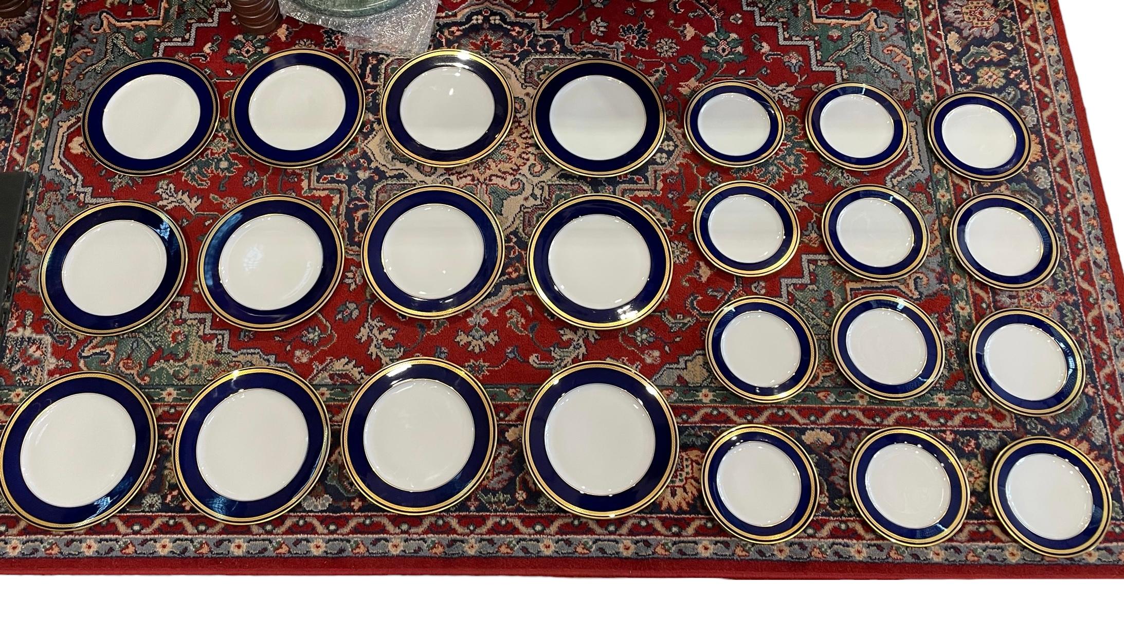 This is a Lorenz Hutschenreuter, Monarch set of 12 dinner plates and 12 salad plates. They depicts a white center with a cobalt blue edge enhanced with a gold braided trim. The salad plate measures 7.63 inches in diameter and 0.13 inches in height.