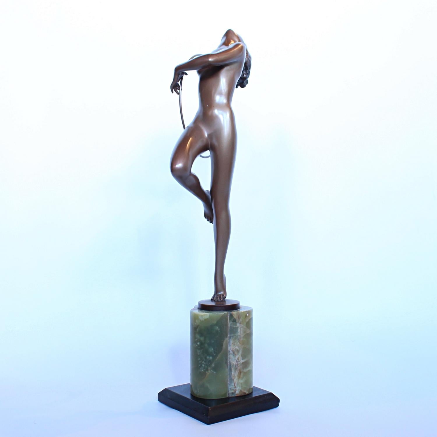 Dancer with Hoop, a cold painted bronze sculpture by Josef Lorenzl (1892-1950). A young lady stands on tiptoe in stylized pose, holding a hoop. Signed Lorenzl to bronze.






 