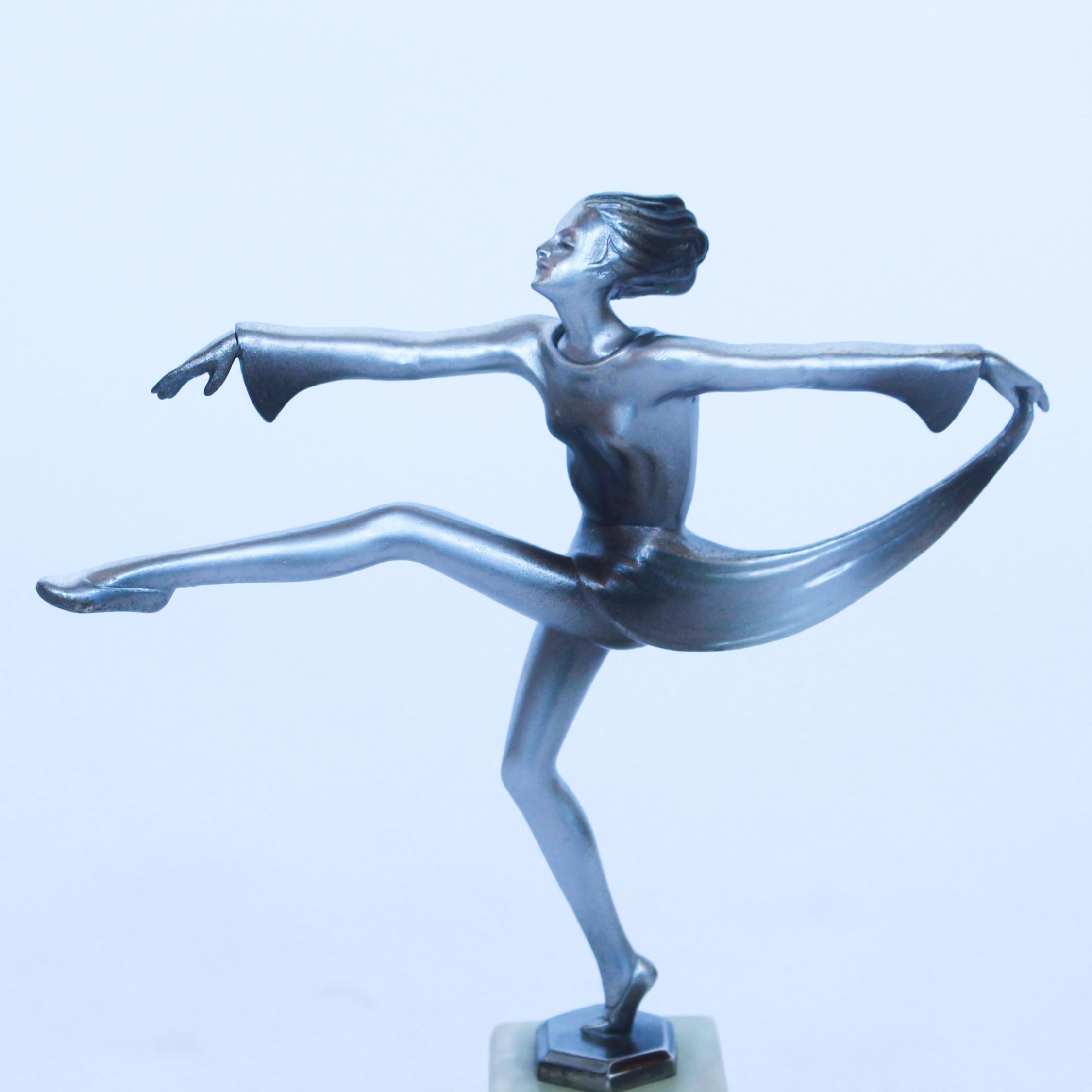 An Art Deco, cold painted bronze figure of an elegant young dancer in a stretched pose, holding out her scarf in a billowing form. Set over a green onyx plinth.

Josef Lorenzl , born in 1892 began his career at a foundry in the Vienna Arsenal.

This