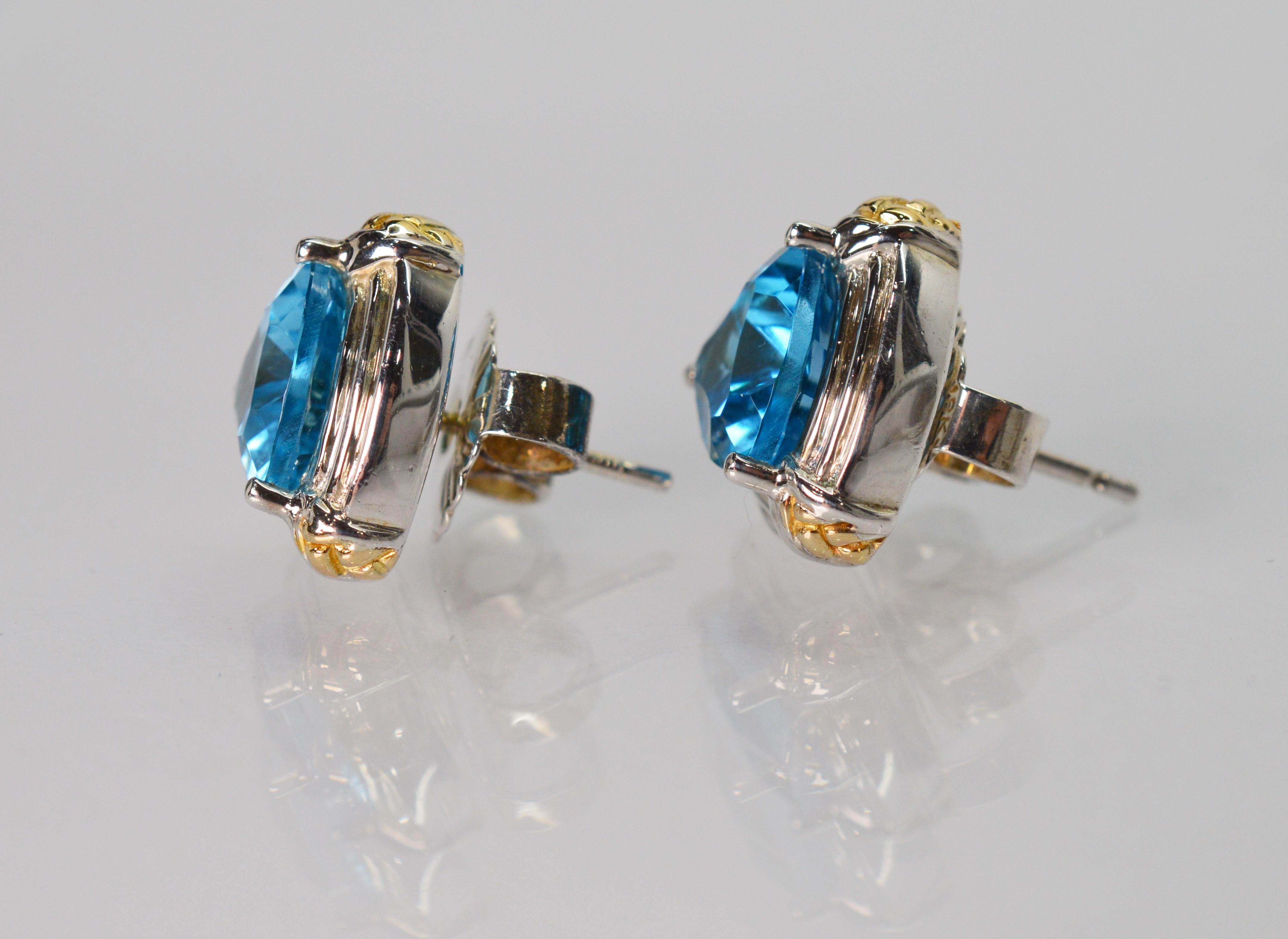 Vibrant London Blue Topaz beam from this cheerful pair of earrings by Lorenzo. Crafted in .925 sterling silver and accented with .750 yellow gold,
each stud showcases a 2.5 carat stone. For pierced ears with post and fancy butterfly closure. Gift