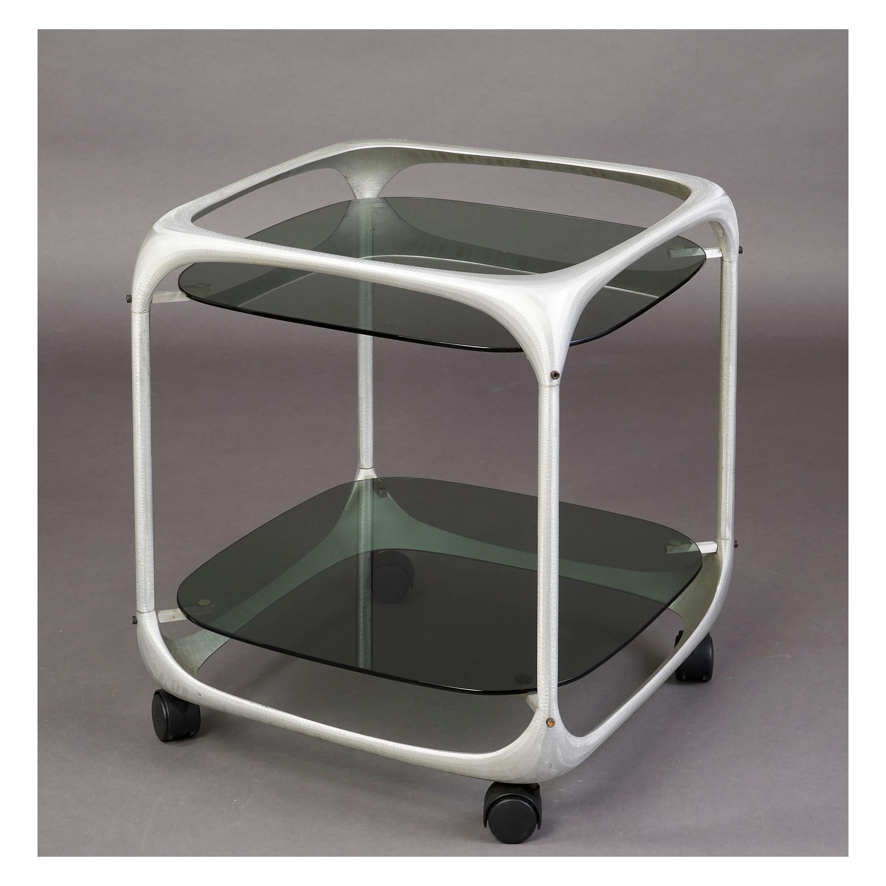 Lorenzo Burchiellaro ( 1933-2017 )
Beautifully cubed two tiered rolling cart with rounded cast and textured aluminium form and smoked glass.
A perfect 1960's Pop Art bar cart.
Italy, 1960's
Measures: 21 x 21 x 24 H.