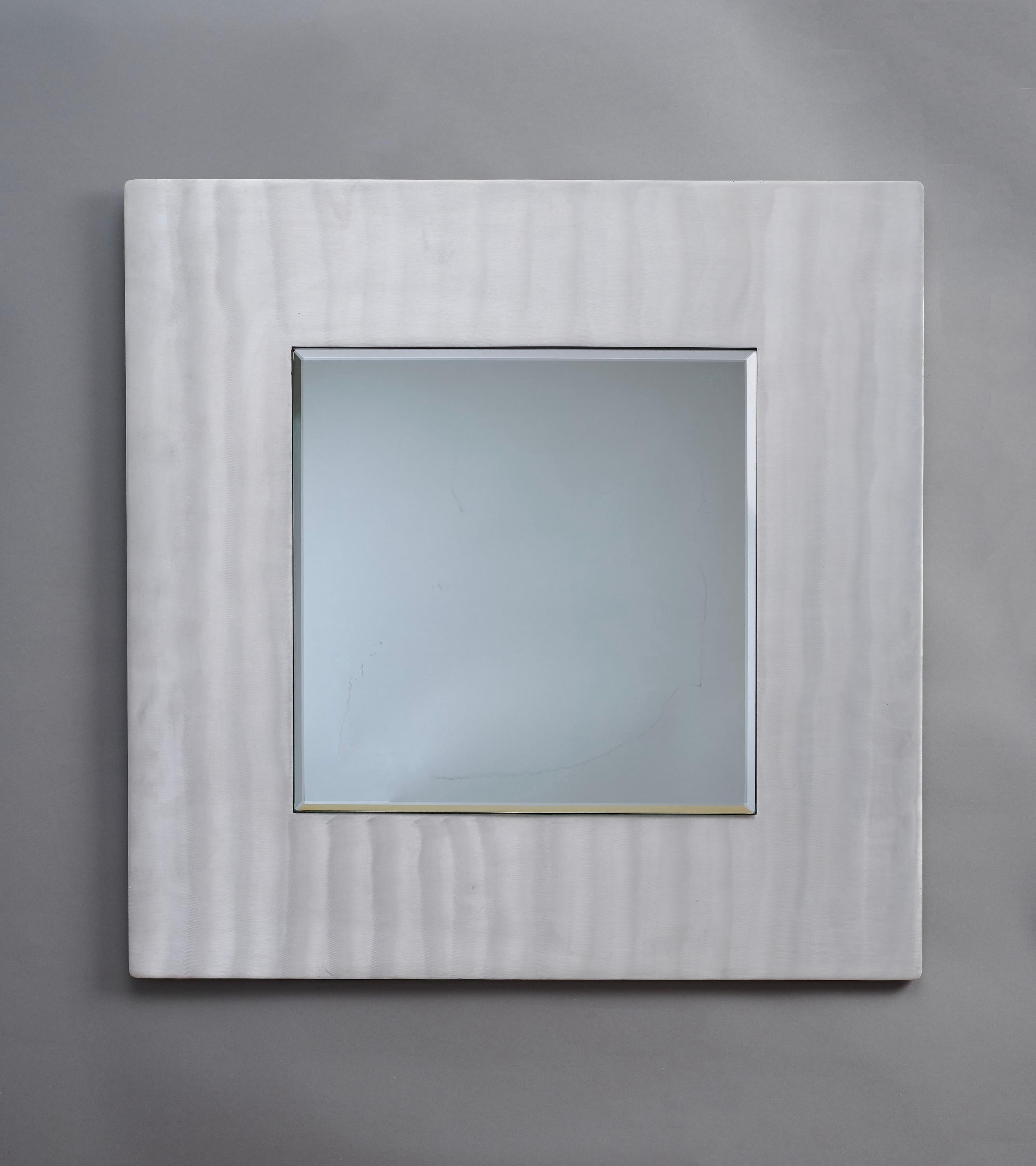 Lorenzo Burchiellaro (b. 1933)

A dynamic square wall mirror by Italian sculptor Lorenzo Burchiellaro, in hand-worked aluminum. The frame's textured surface is etched and brushed in gestural vertical waves, causing light to ripple and dance. 

A
