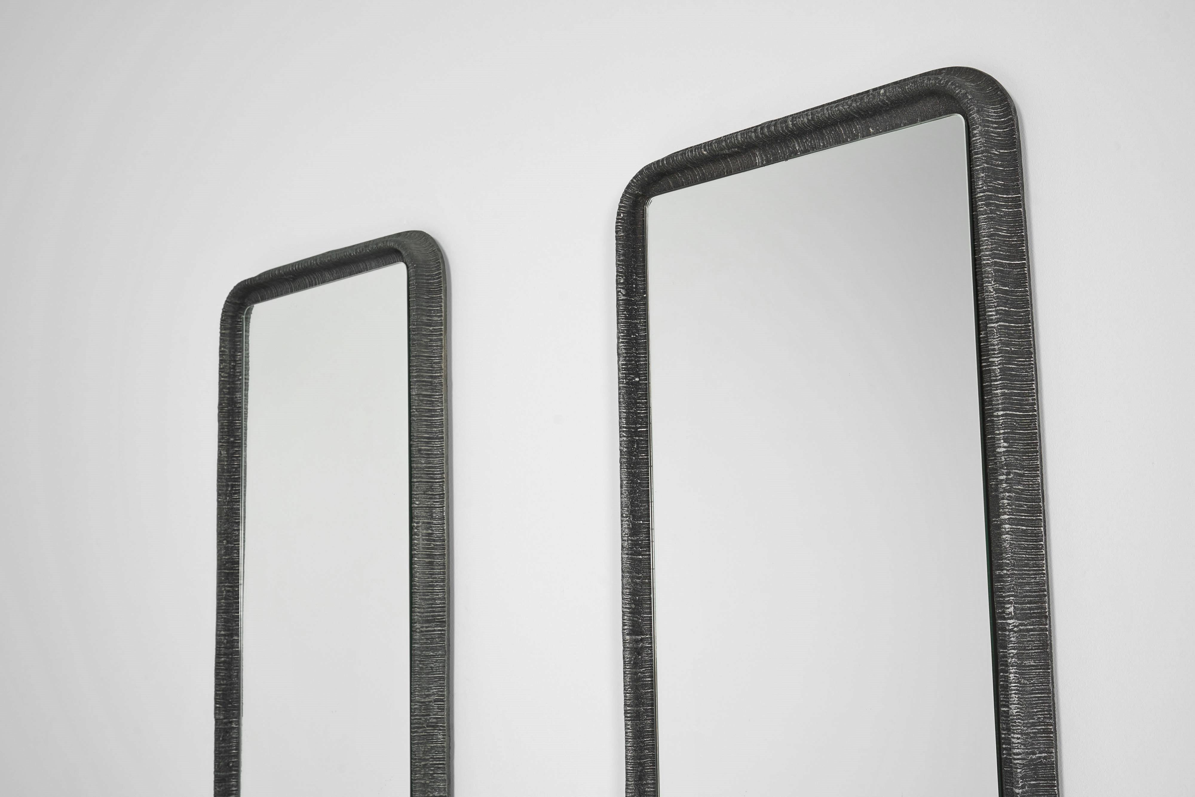 Great Lorenzo Burchiellaro wall mirrors, created in Italy in 1975. These mirrors are a true artistic marvel with their distinctive ribbed cast aluminum edges. The unique feature of these mirrors is the textured edges made of ribbed cast aluminum.