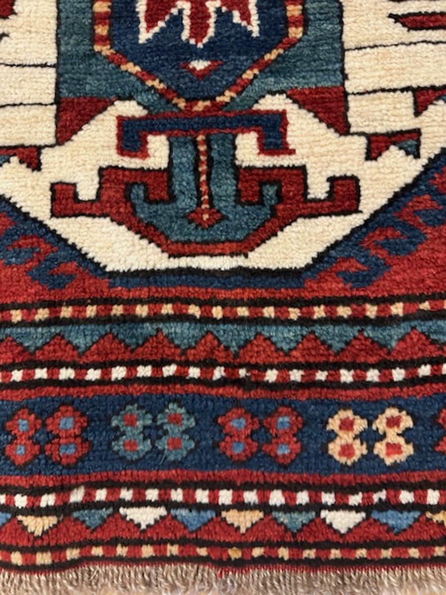 Lori Pambak Kazak rug from southwest Caucasus,Armenia

Age: circa 1895

Size: 6′.8″x4′.3″ (203×130 cm)

This classic three medallion Lori Pambak Kazak rug shows two ivory hexagons with light green sub medallions expressing stylized palmettes,a