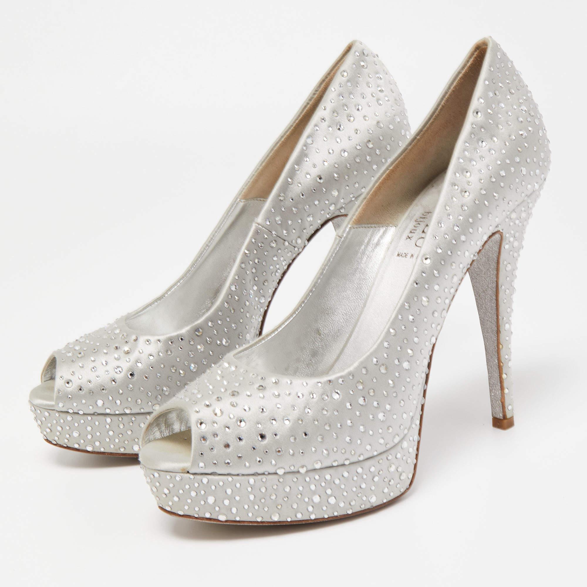 These gorgeous platform pumps from Loriblu simply stand out Covered in crystal embellished silver satin they flaunt peep toes and come endowed with comfortable leather lined insoles. They stand tall on 15cm heels along with platforms and will look