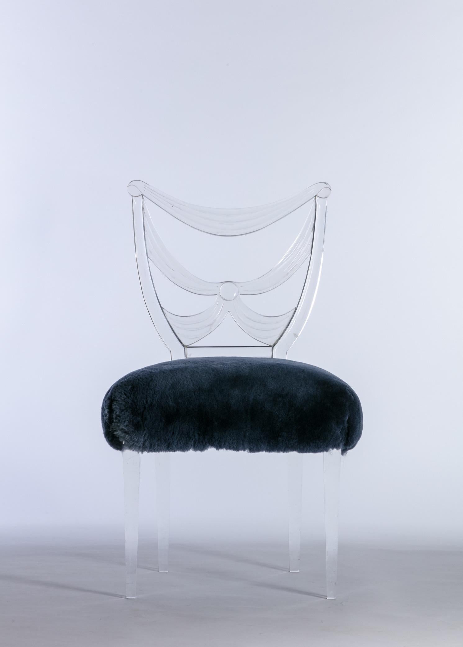 Grosfeld House Glassic collection drapery back Lucite side / desk / vanity chair with midnight blue shearling upholstery. Designed by Lorin Jackson, this collection debuted at the 1939 New York world’s fair. Karl Lagerfeld and Andy Warhol both had