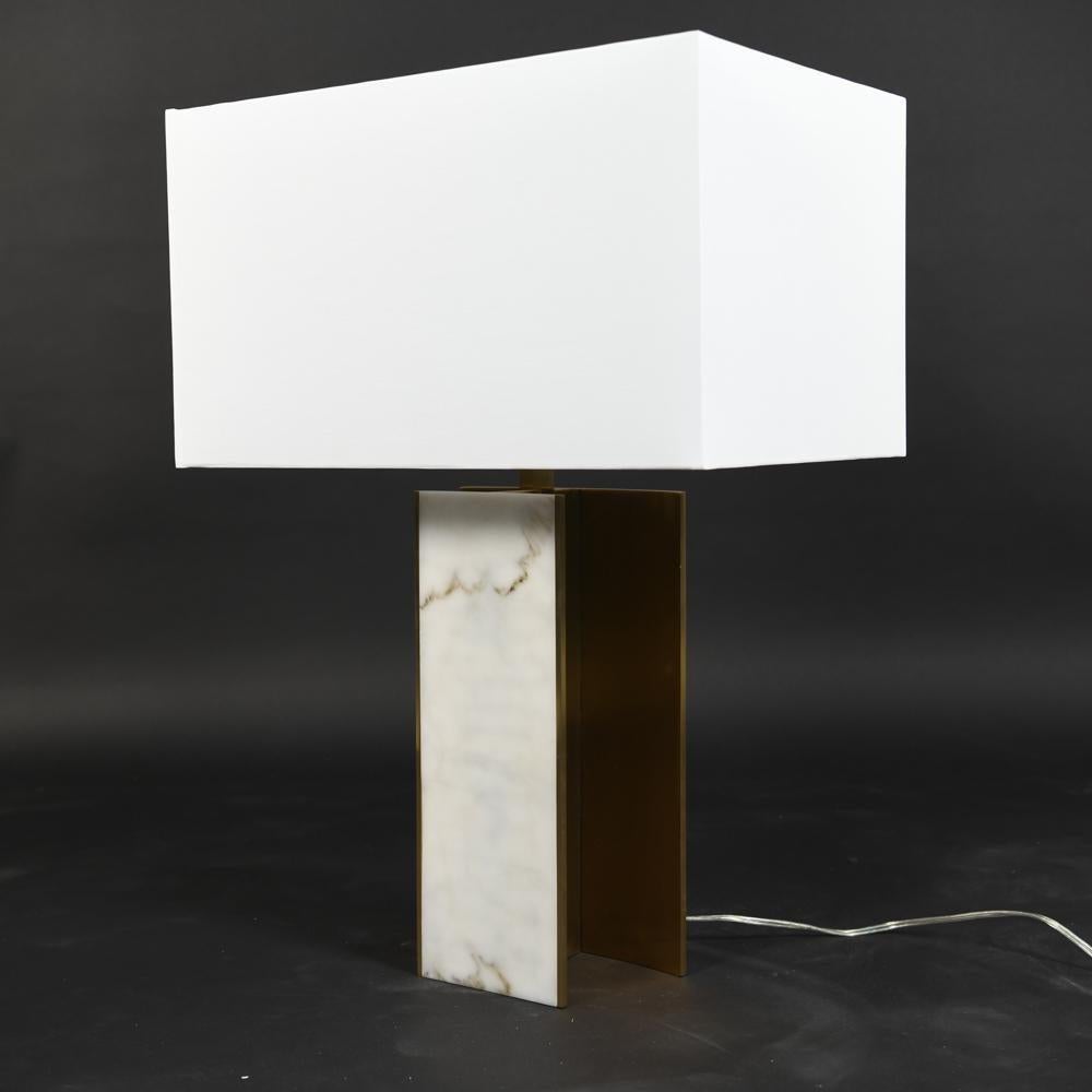Lorin Marsh design table lamp. New York Unsigned. Patinated brass. Faux alabaster insert on base. Linen shade. Shade included measures 13 inches height, 21.5 width, and 15 depth. This large and impressive table lamp is sure to light up and sparkle